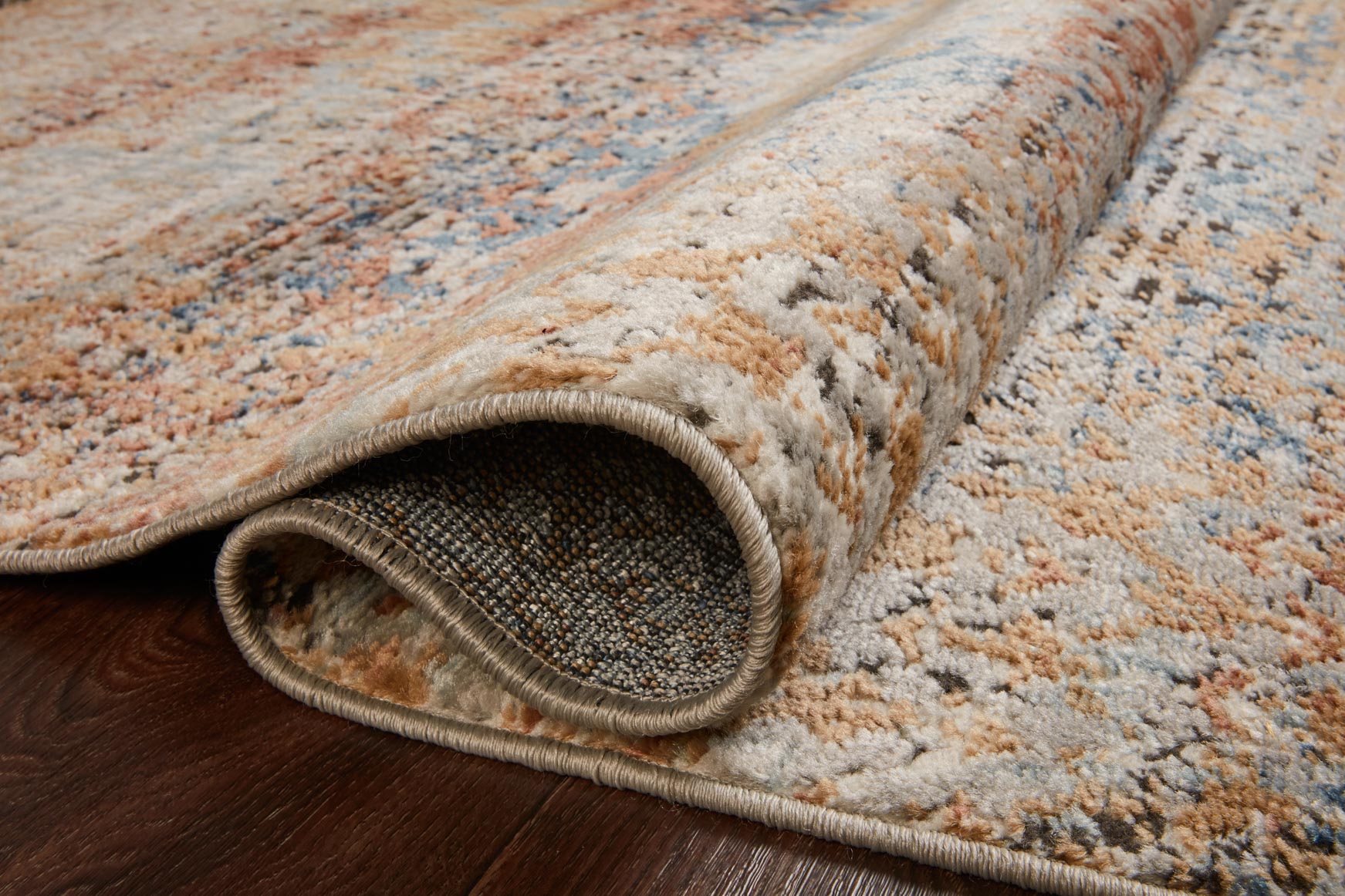Rolled rug edge with serged border, low pile, multicolor blue and beige