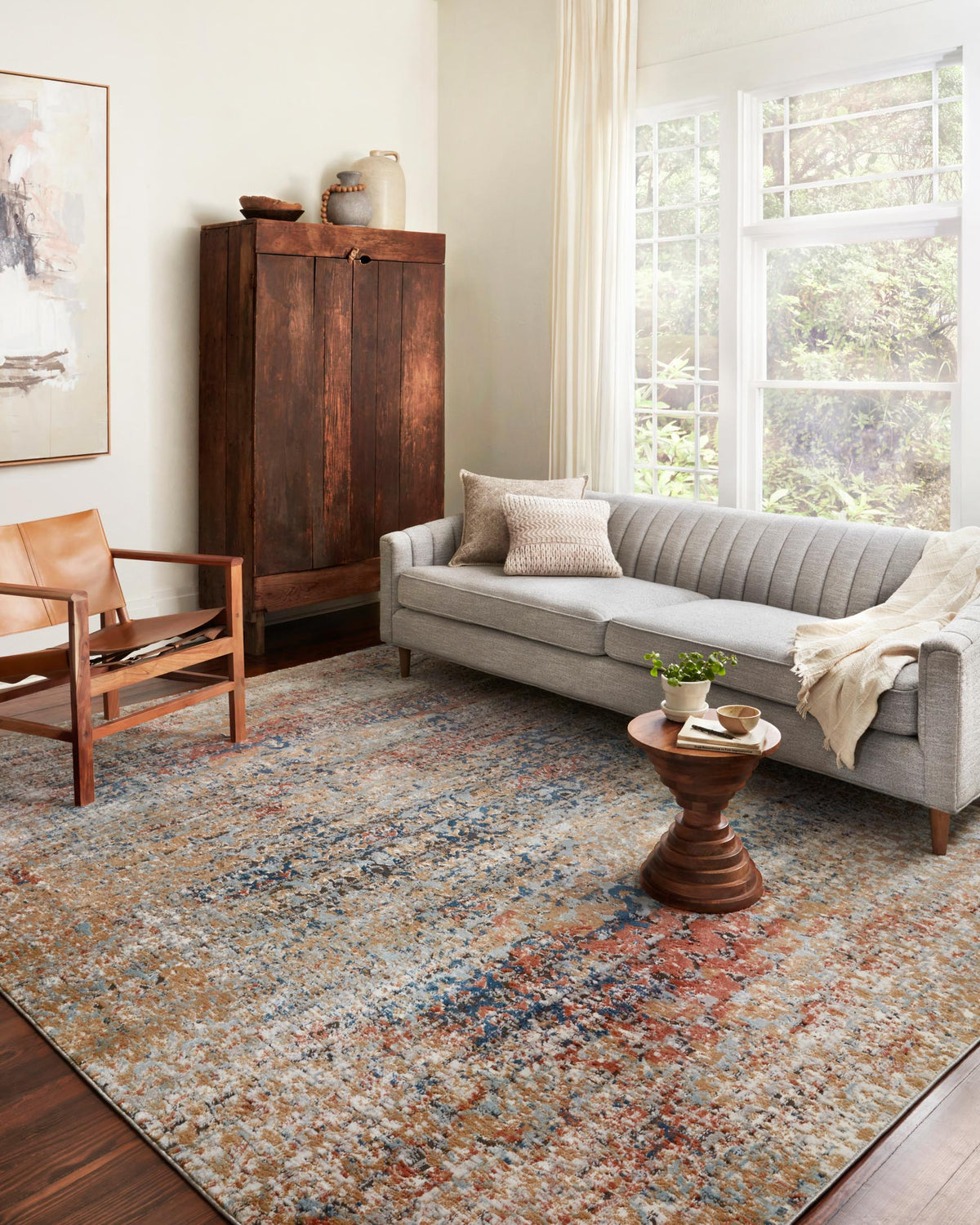 Large multicolor area rug with abstract speckled pattern in blue and spice tones