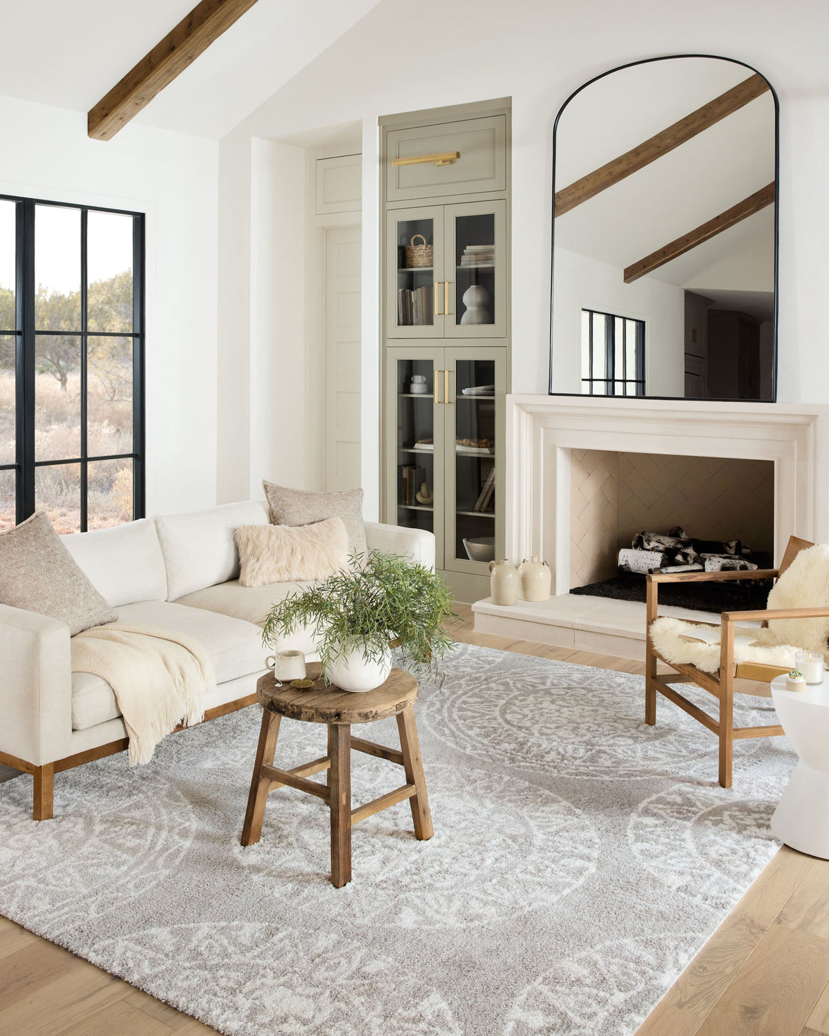 Grey and white shag rug with ornate pattern, styled in a living room setting