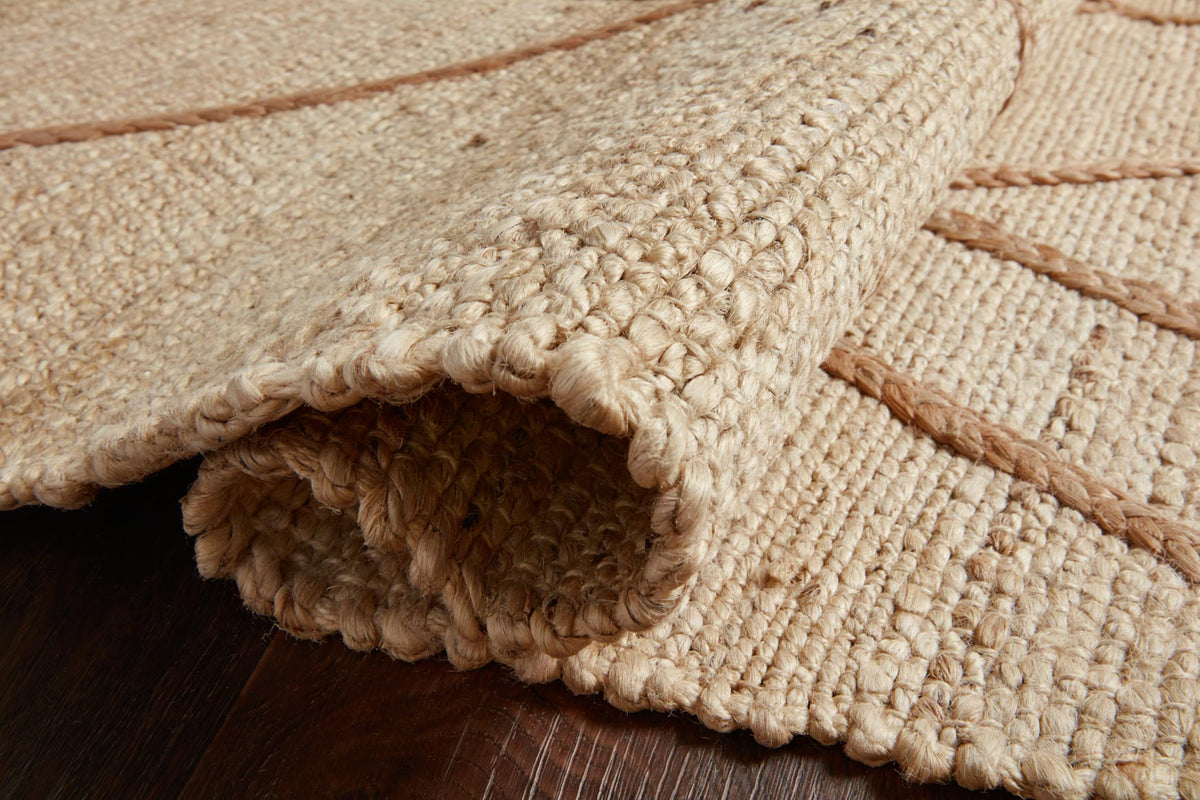 Rug edge close-up with looped hand-woven pile, ivory yarn and tan lattice stitch lines