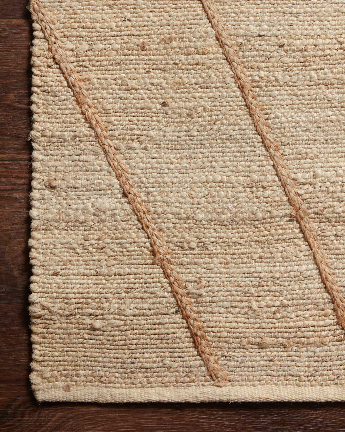 Close-up of ivory rug weave and warm rust diamond stripe pattern