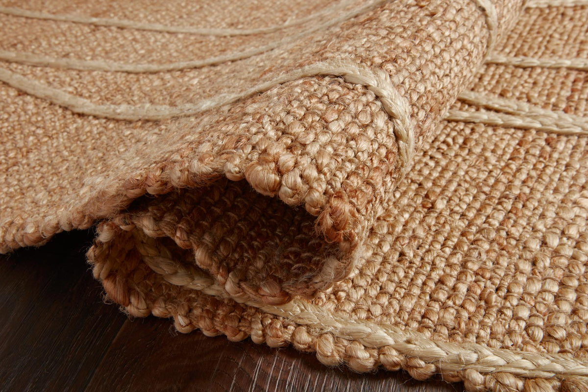 Close-up of rug edge: tan woven texture with ivory line accents