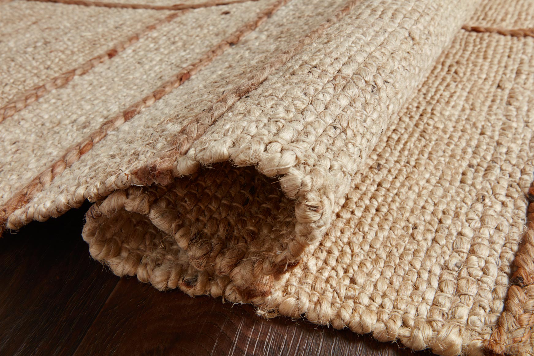 Ivory and natural hand-woven rug edge detail, braided fringe and loop texture.