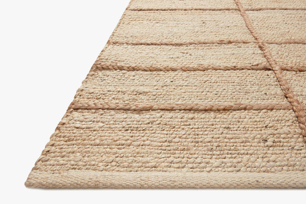 Ivory and natural hand-woven rug corner close-up, textured loop pile.