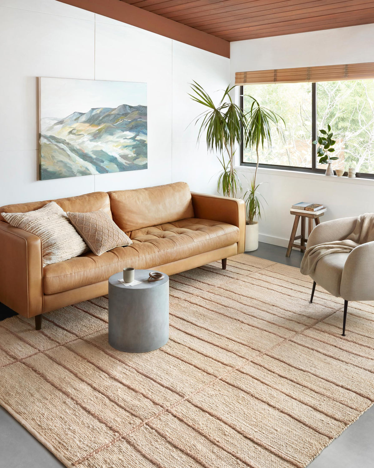 Ivory and natural hand-woven rug with linear geometric grid pattern.