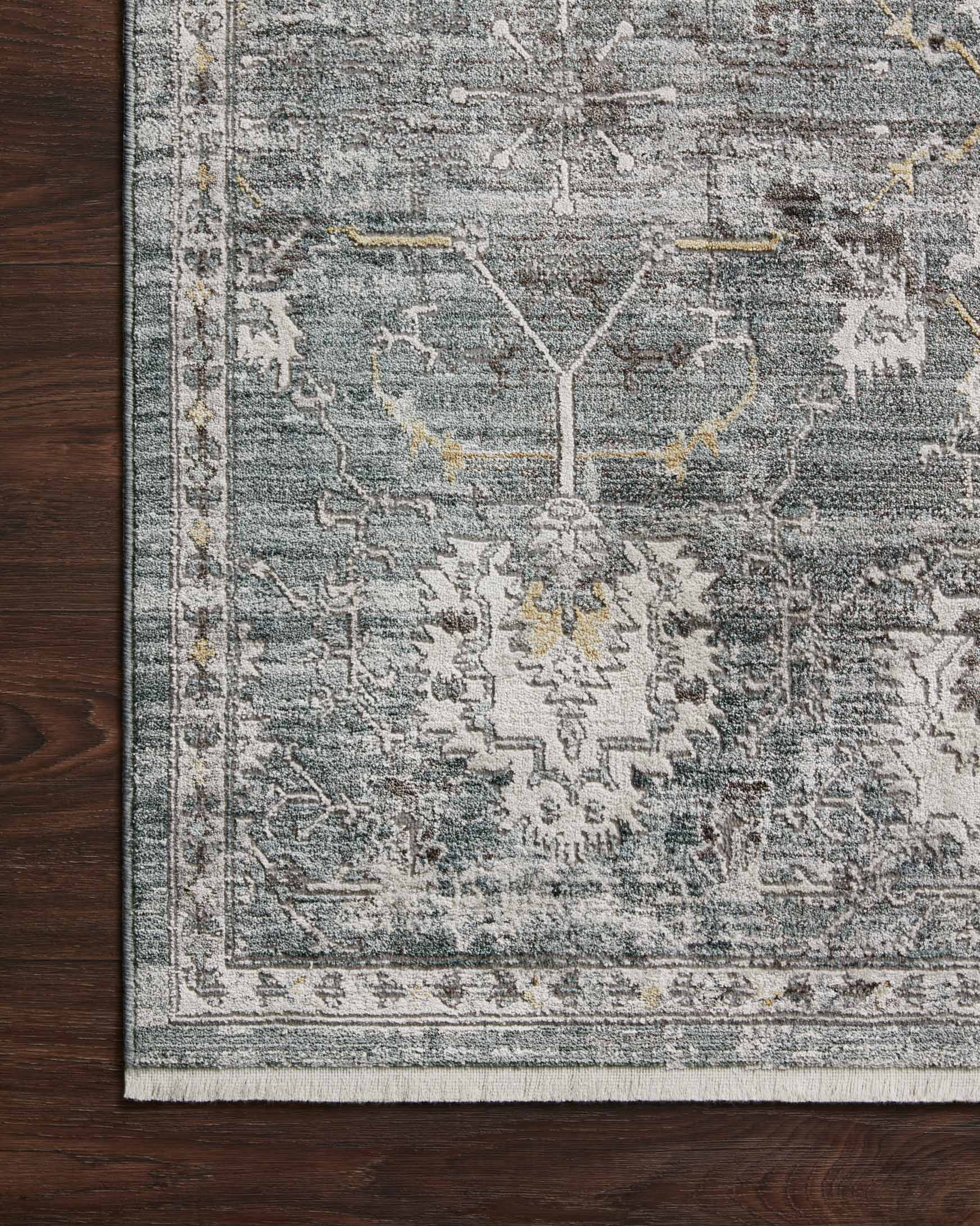 Lagoon rug detail with distressed lines, ivory motifs, and framed border