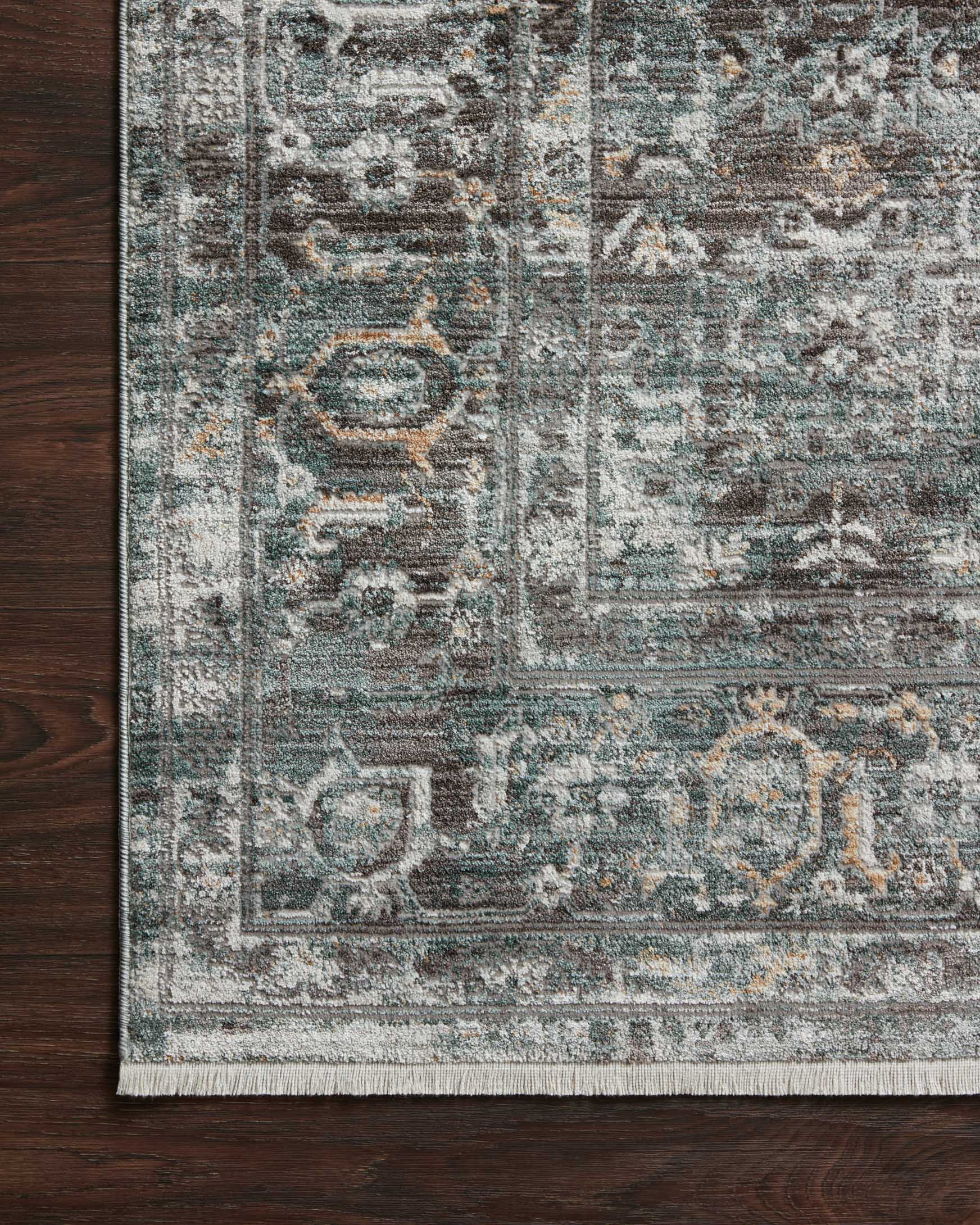 Traditional power-loomed rug border close-up in slate gray with short fringe