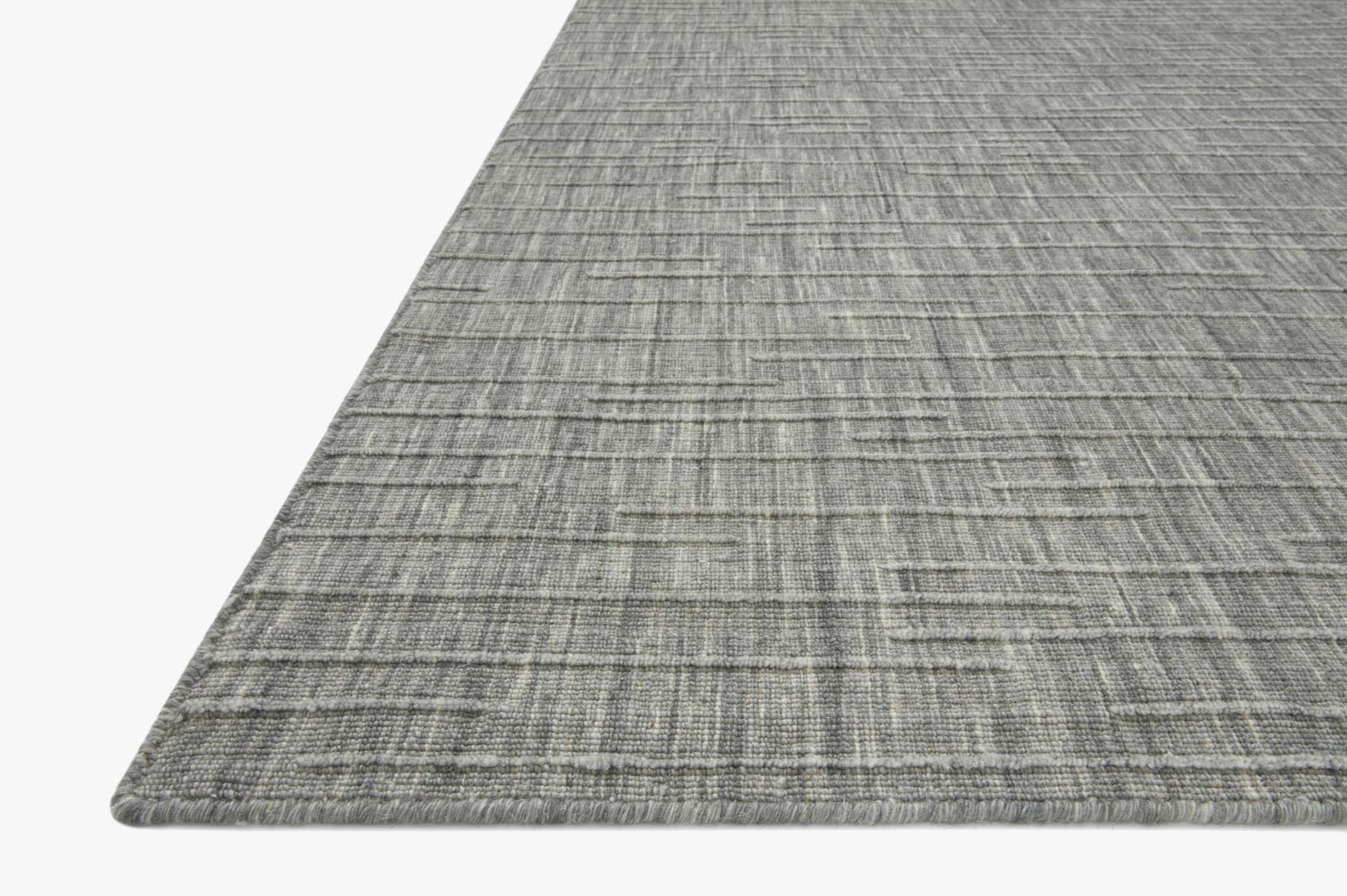 Grey flat-woven area rug corner showing border and tightly spaced grid texture