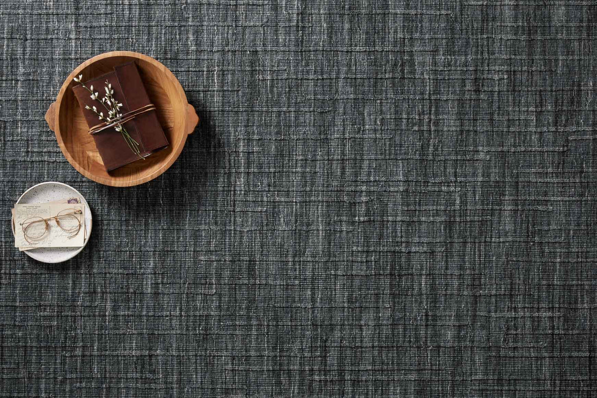Ink blue hand-woven rug featuring fine grid lines and evenly textured surface