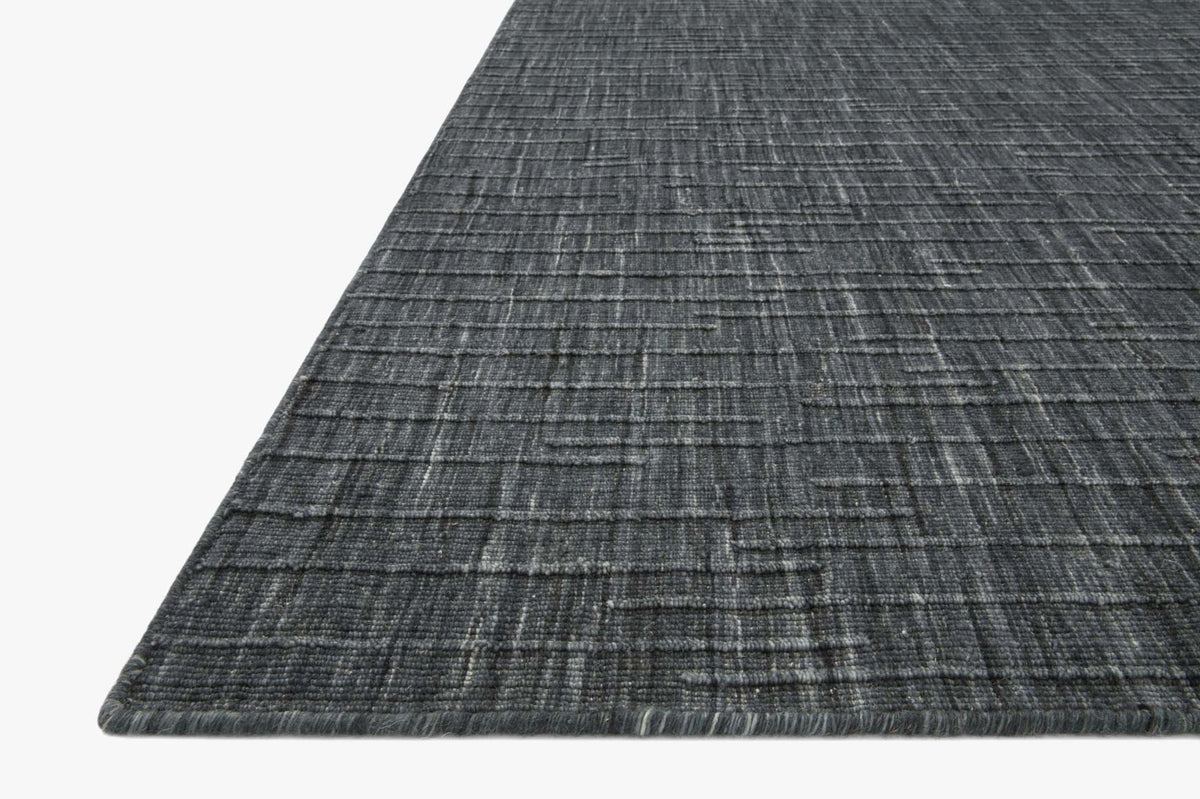 Corner detail of dark ink blue hand-woven rug with low-pile textured weave