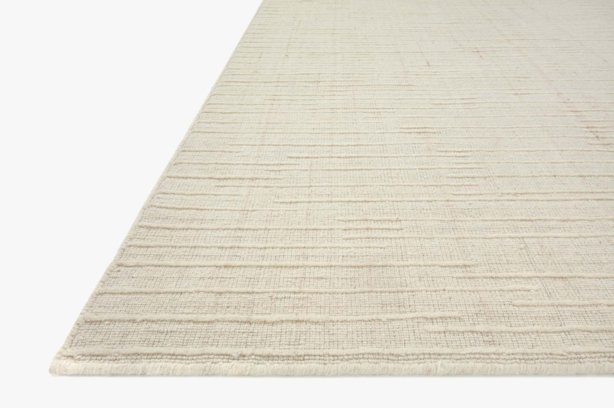 Ivory hand-woven rug corner detail with textured horizontal lines