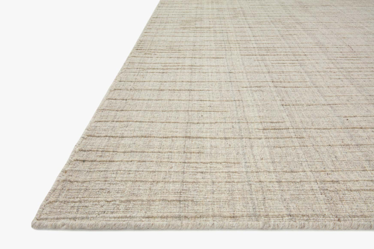 Stone contemporary hand-woven rug corner detail with low-profile flatweave texture
