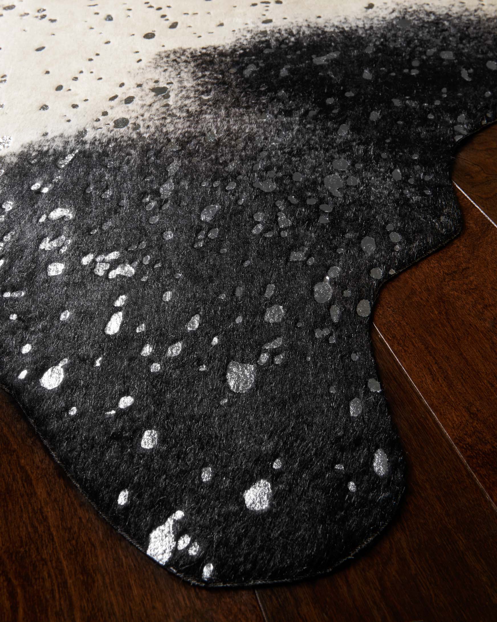 Close-up of black rug with silver speckles and mottled splatter texture