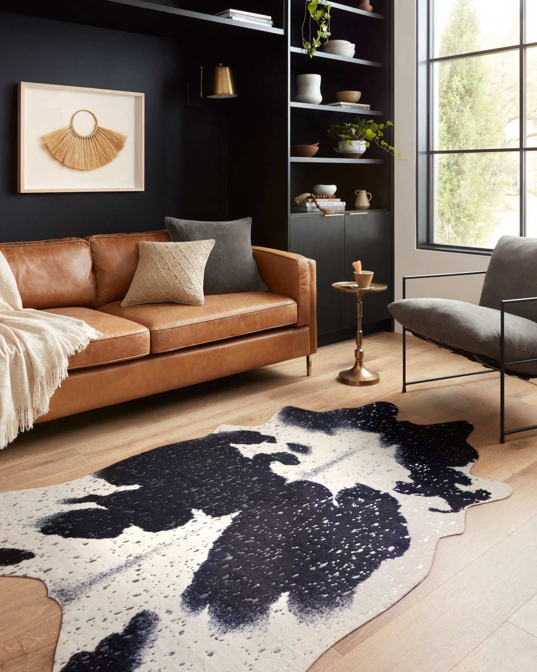 Abstract cowhide-style rug with black and silver mottled splash pattern