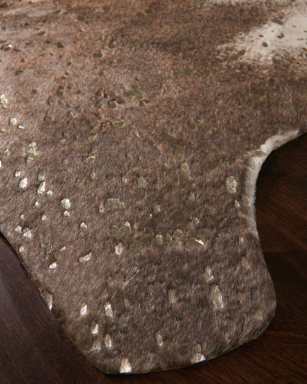 Walnut and champagne rug with dense mottled speckle and short pile, corner detail