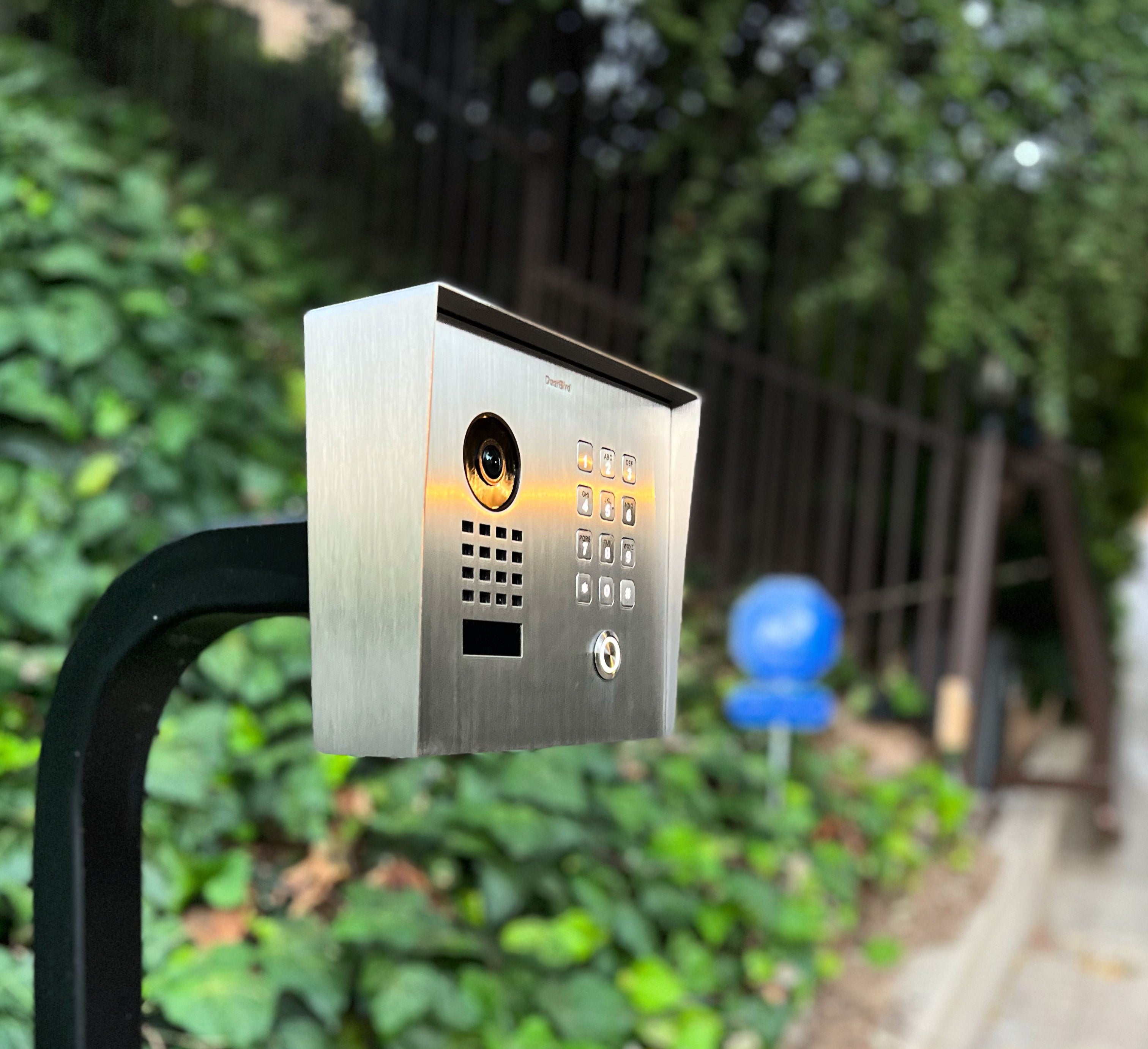 Outdoor stainless steel video intercom with call button, speaker grille, and camera lens