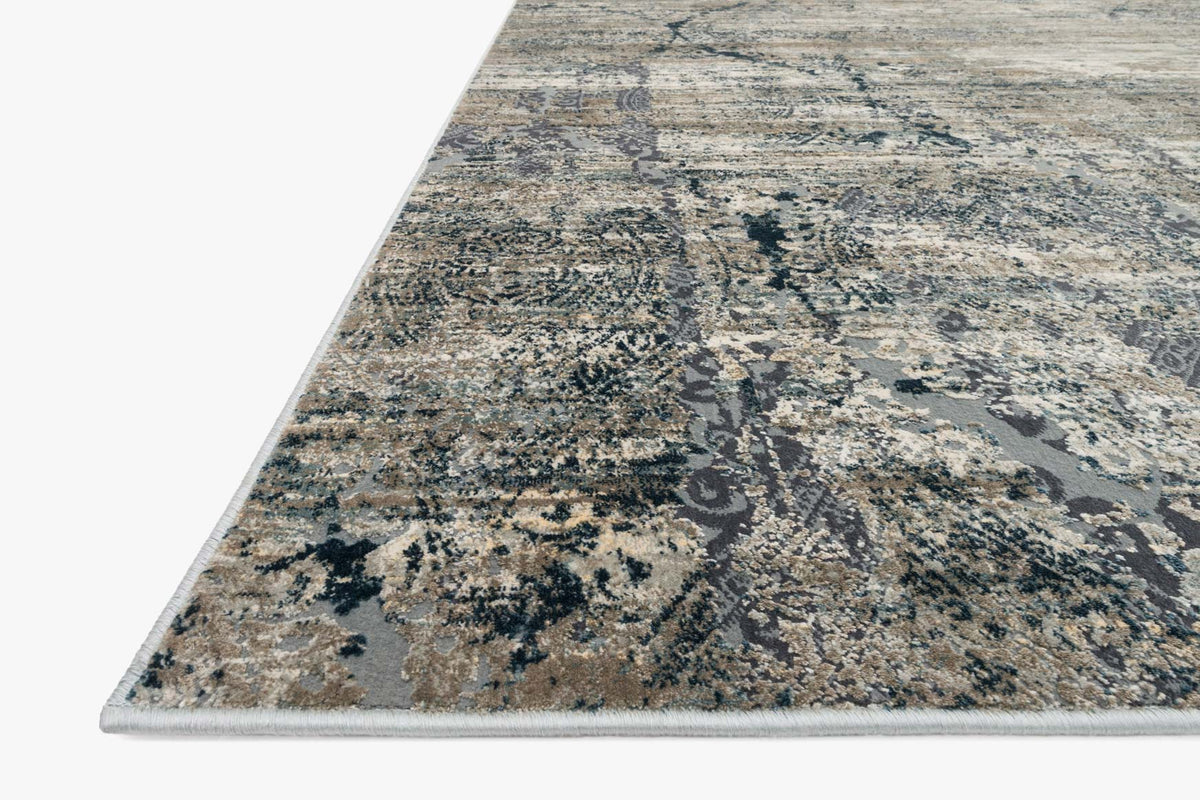 Abstract power-loomed rug corner showing taupe and blue distressed motif