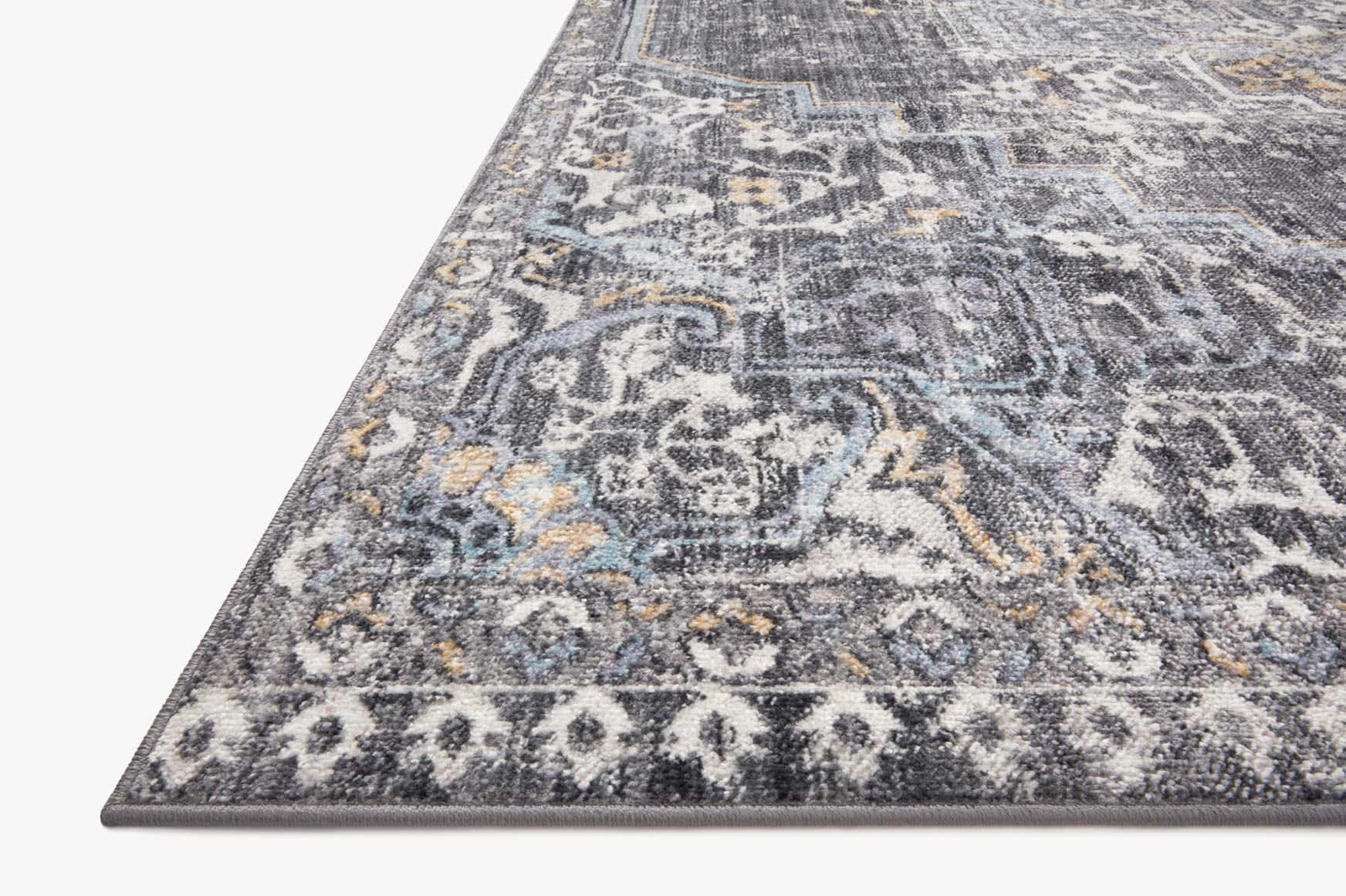 Charcoal rug with intricate center motif and gold accents, diagonal wide view