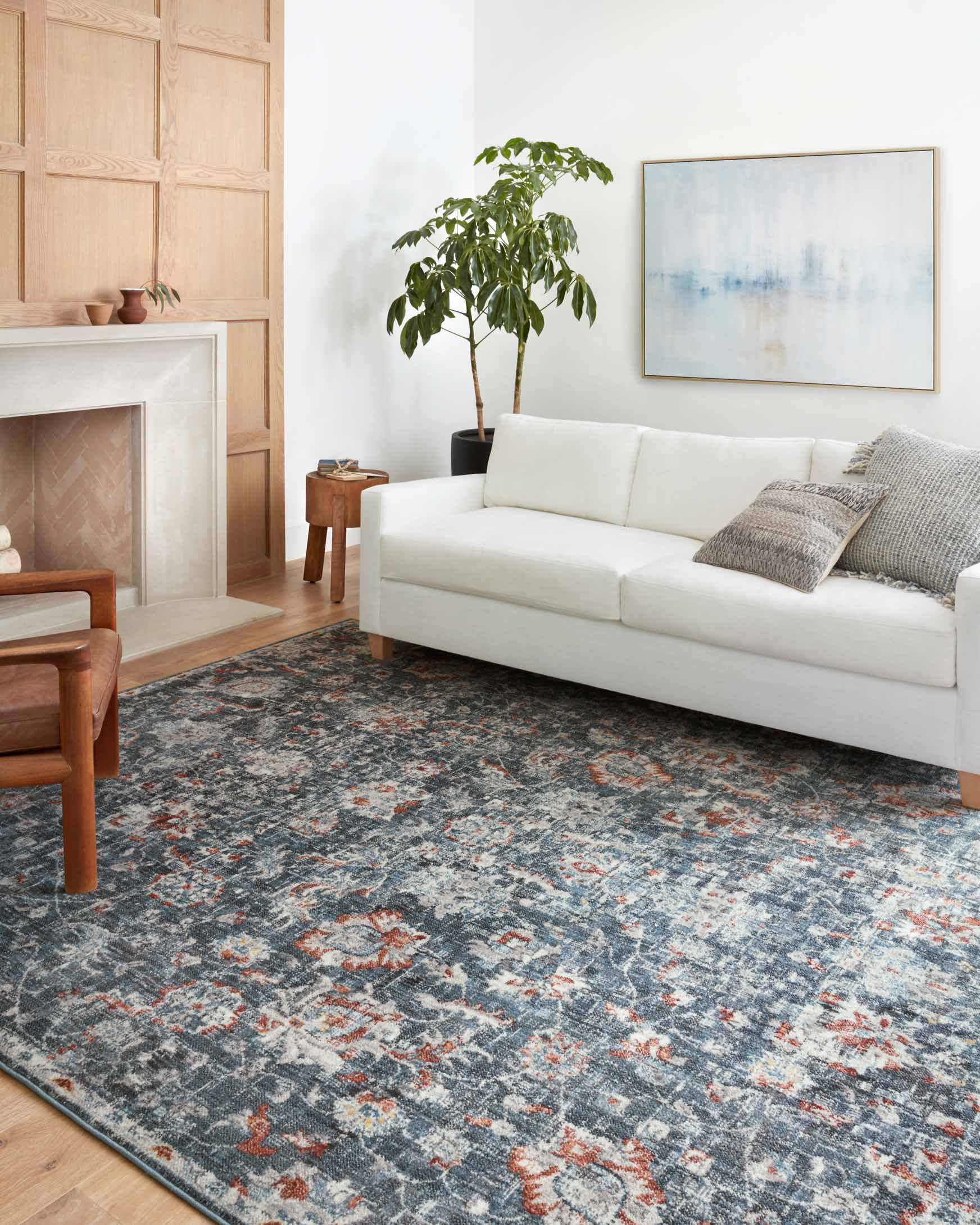 Blue and rust area rug with traditional medallion pattern and dark border