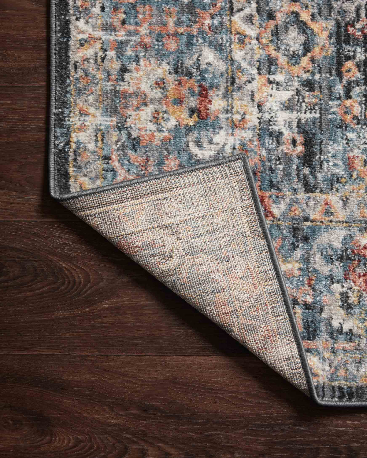 Blue multicolor area rug with visible reversed weave and dark border trim