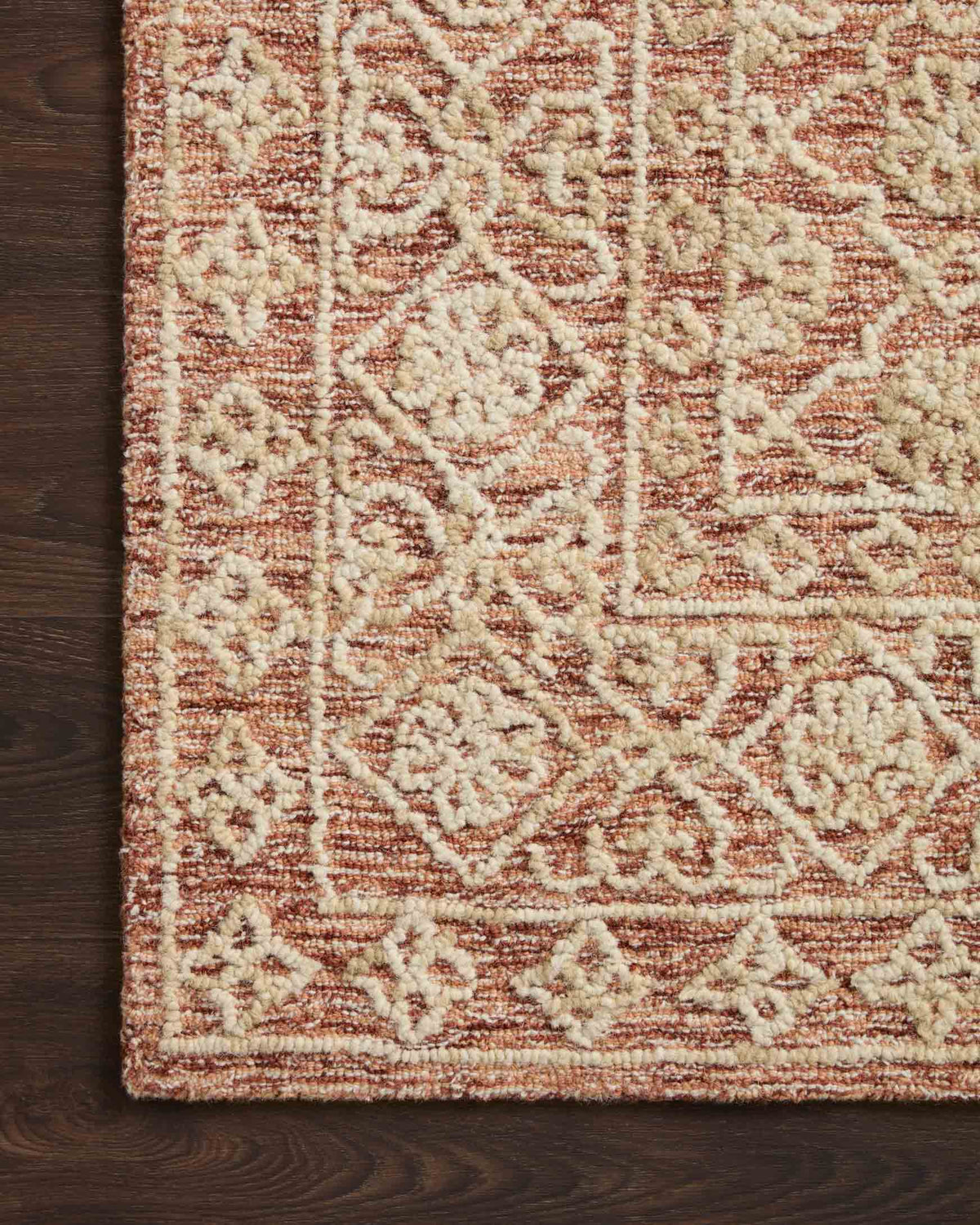 Rust and natural hand-tufted rug surface with raised geometric pattern detail