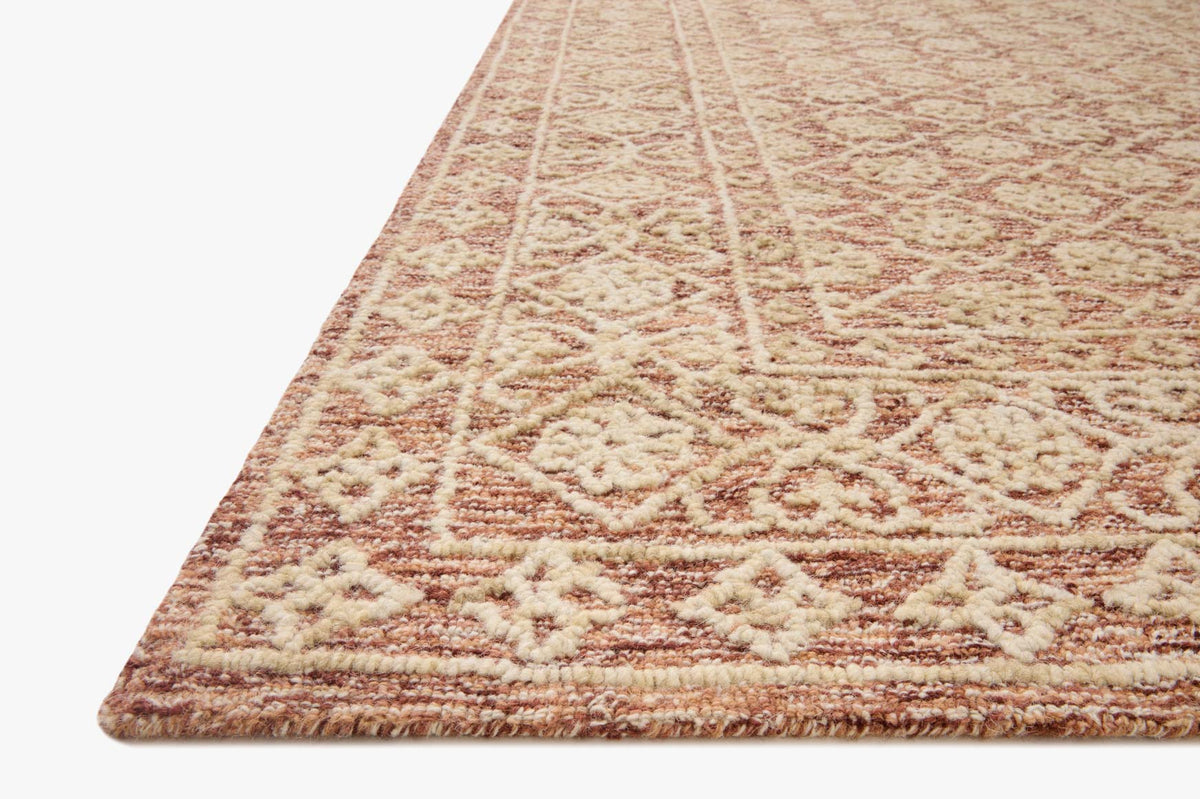 Rust and natural hand-tufted rug corner close-up, textured geometric pattern
