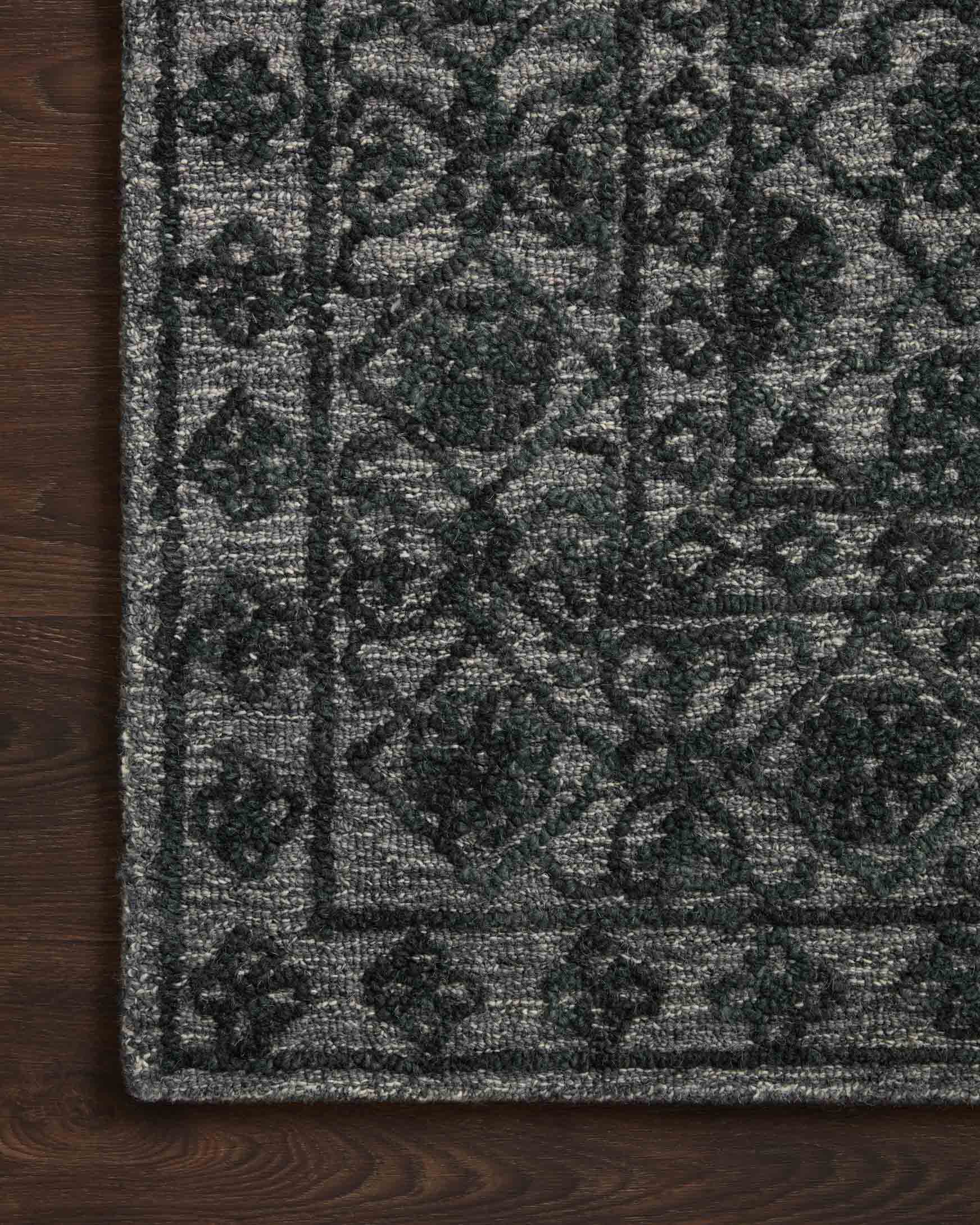 Contemporary hand-tufted rug with textured smoke-gray field and dark geometric lattice border