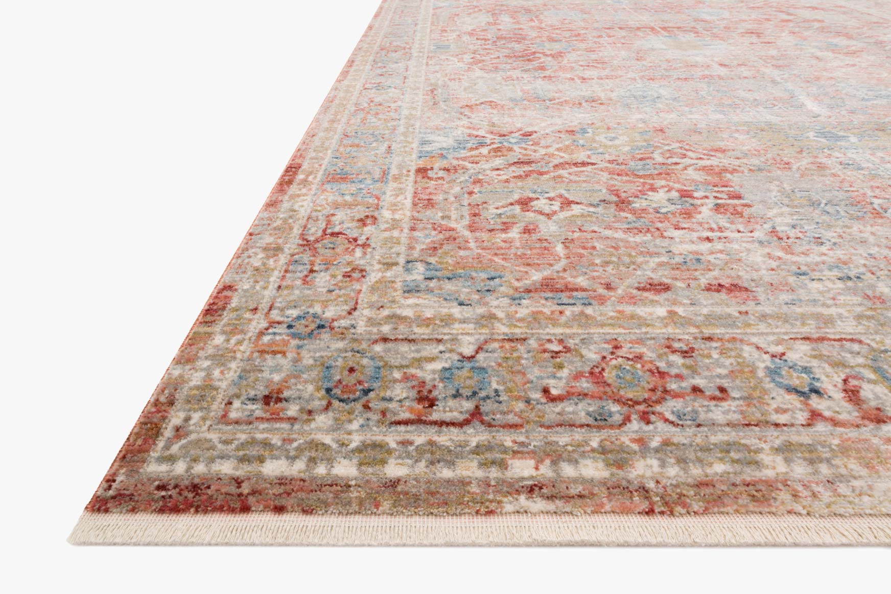 Red and ivory traditional power-loomed rug corner, ornate border and central distressed design.