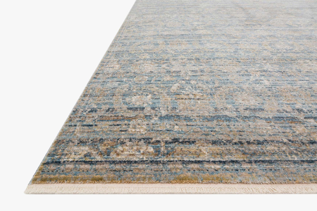 Traditional rug corner with ocean blue, gold, and beige distressed abstract weave
