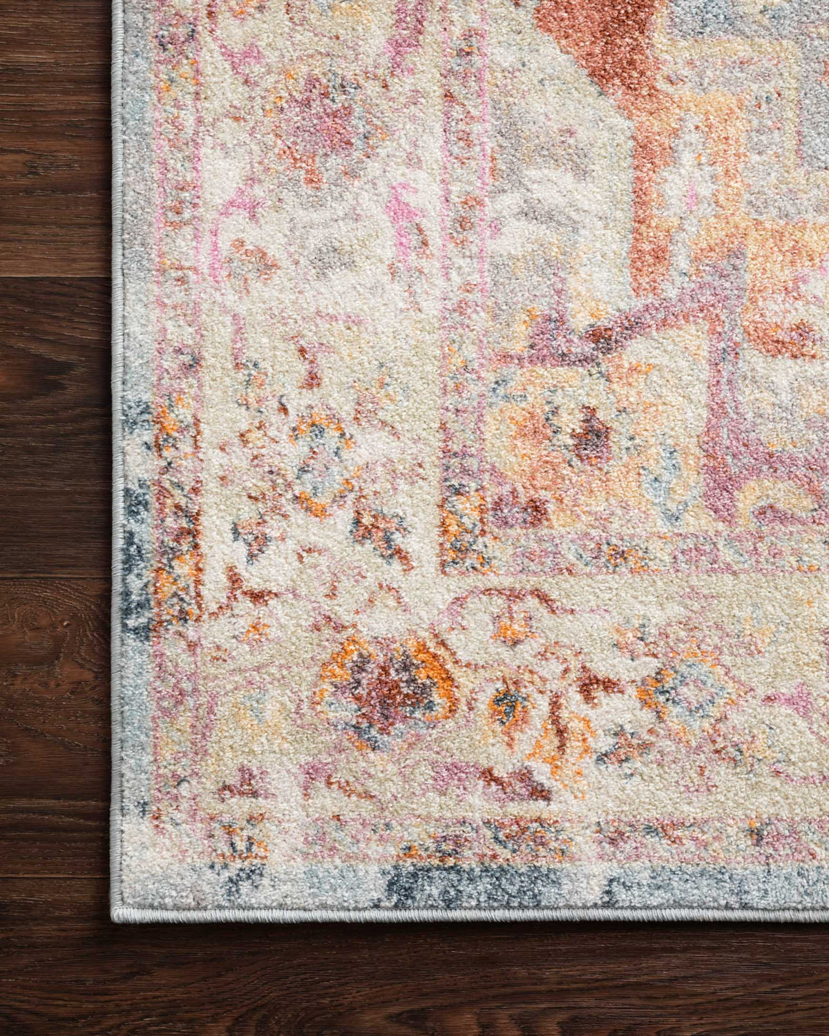 Transitional rug corner with ivory, light blue and rust abstract motif on pile
