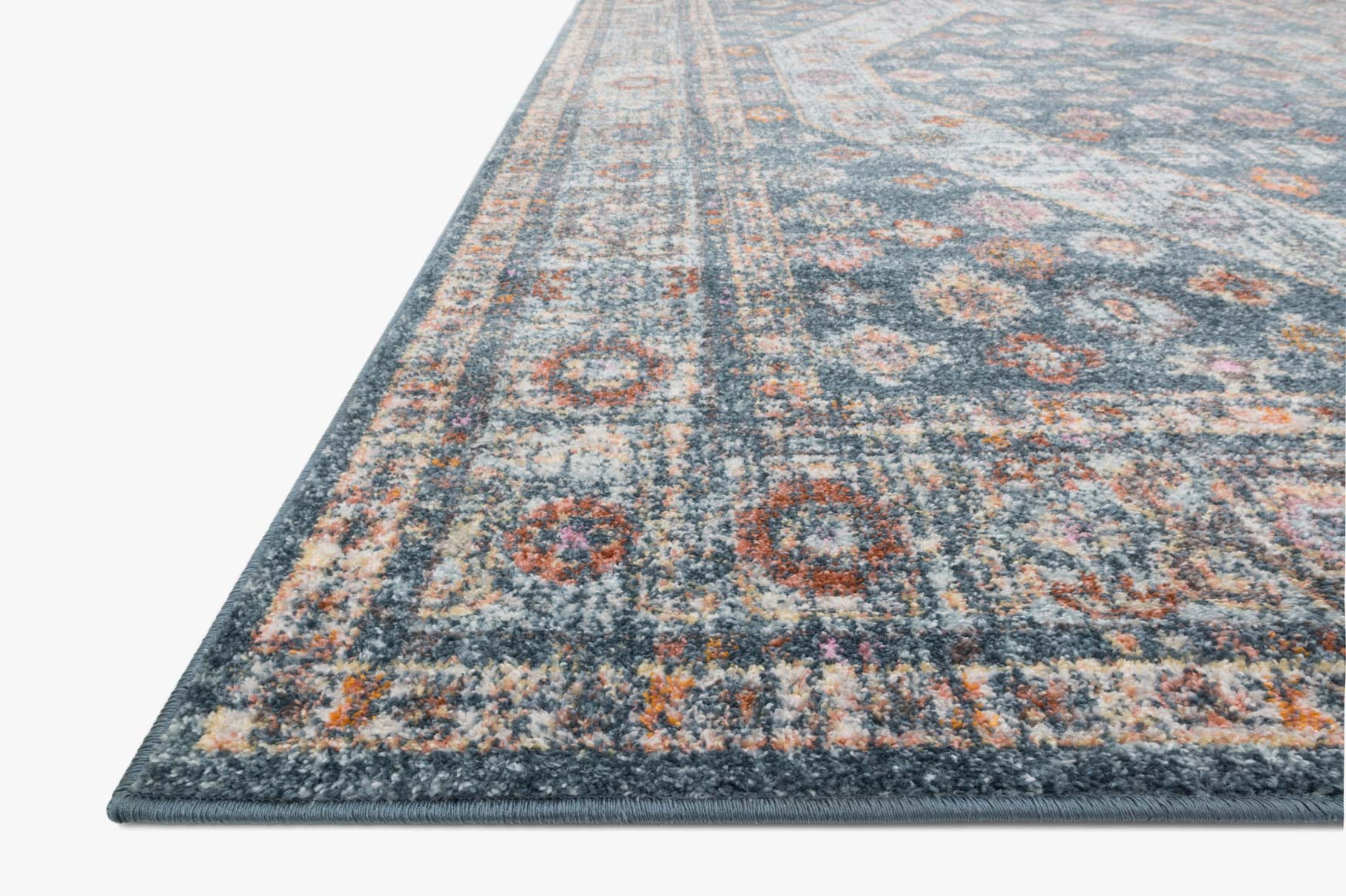 Blue and light blue power-loomed rug corner with border stripe and distressed pattern