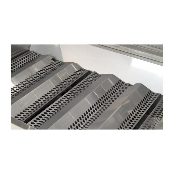 Stainless steel grilling grates with evenly spaced slots inside the firebox
