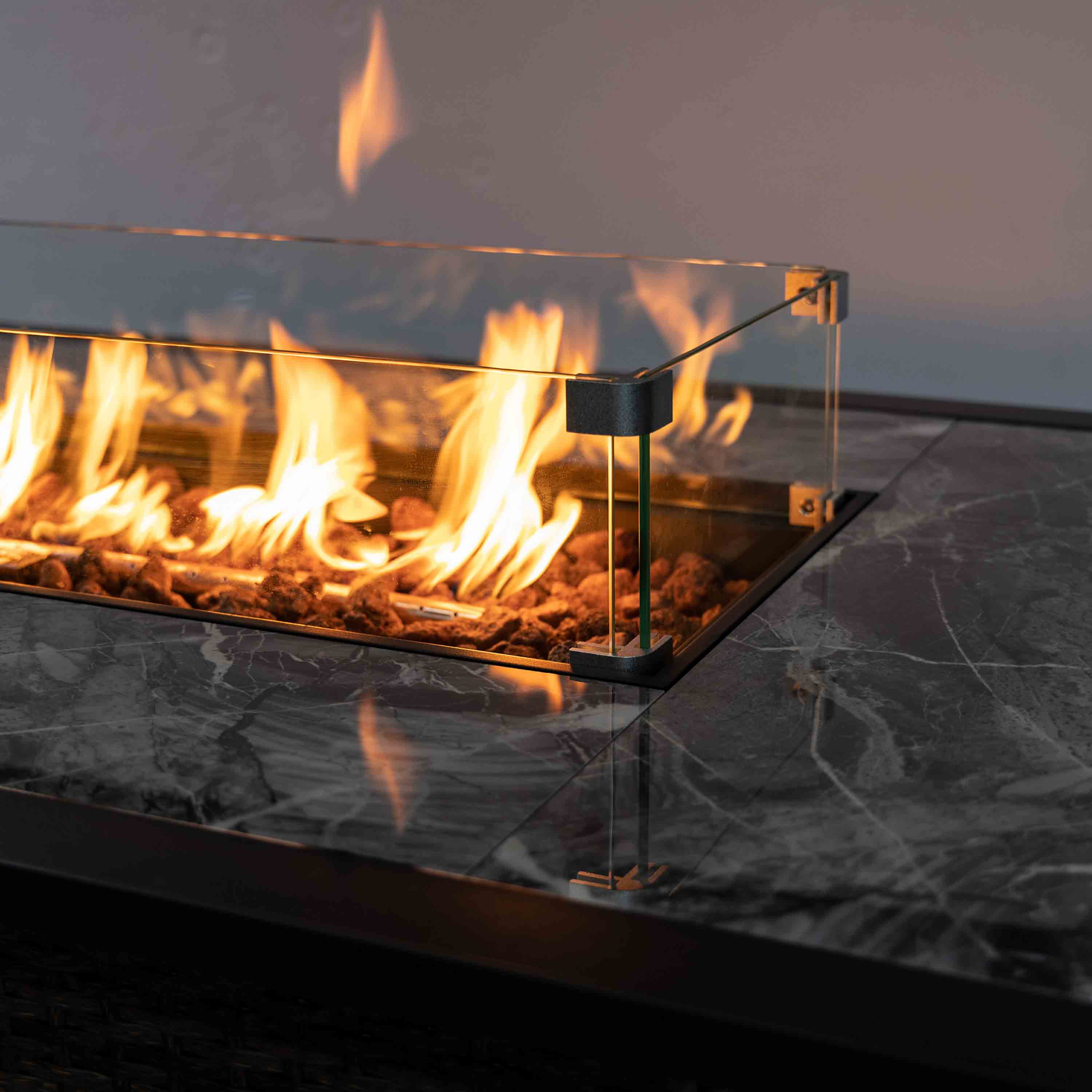 Brown wicker propane fire pit with flame guard and clear glass sides