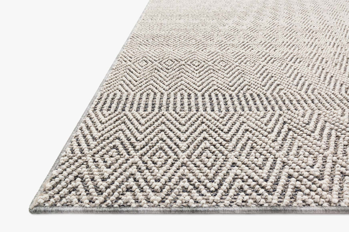 Grey and bone rug corner with textured loop pile and diamond chevron weave