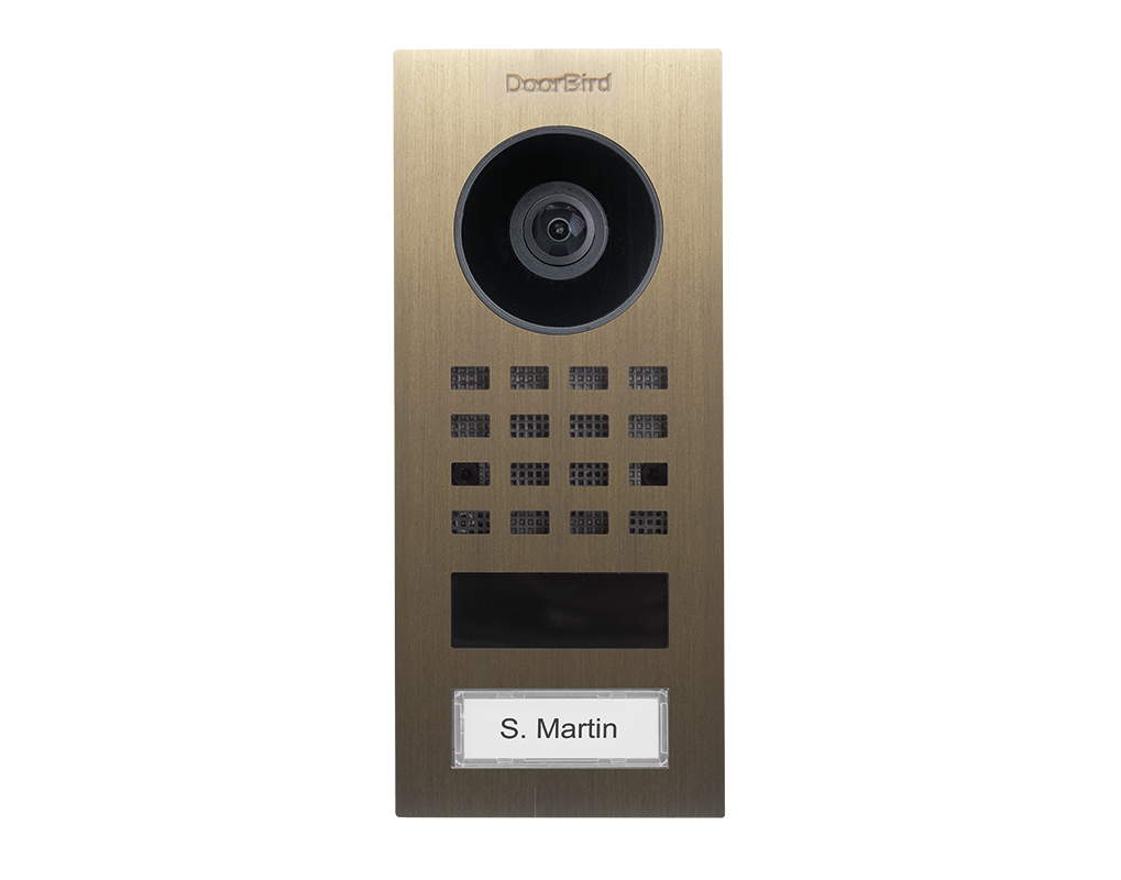 DoorBird burnished brass surface video intercom with camera lens, keypad grid, name badge