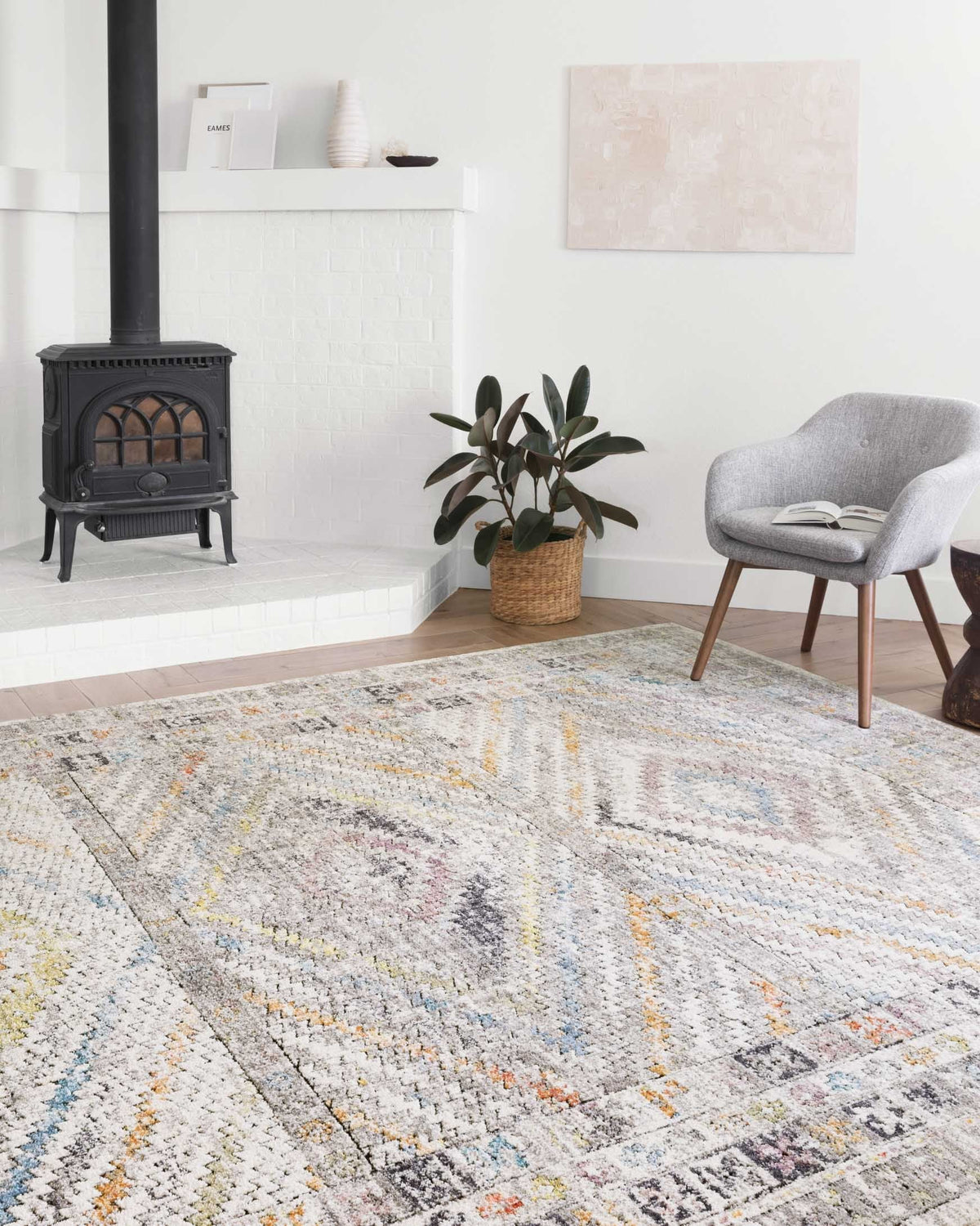 Ivory geometric rug with multicolor pattern in a bright living room setting