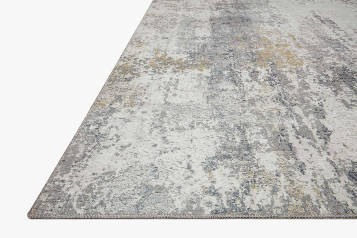 Ivory and gray abstract distressed area rug with visible border on angled view.
