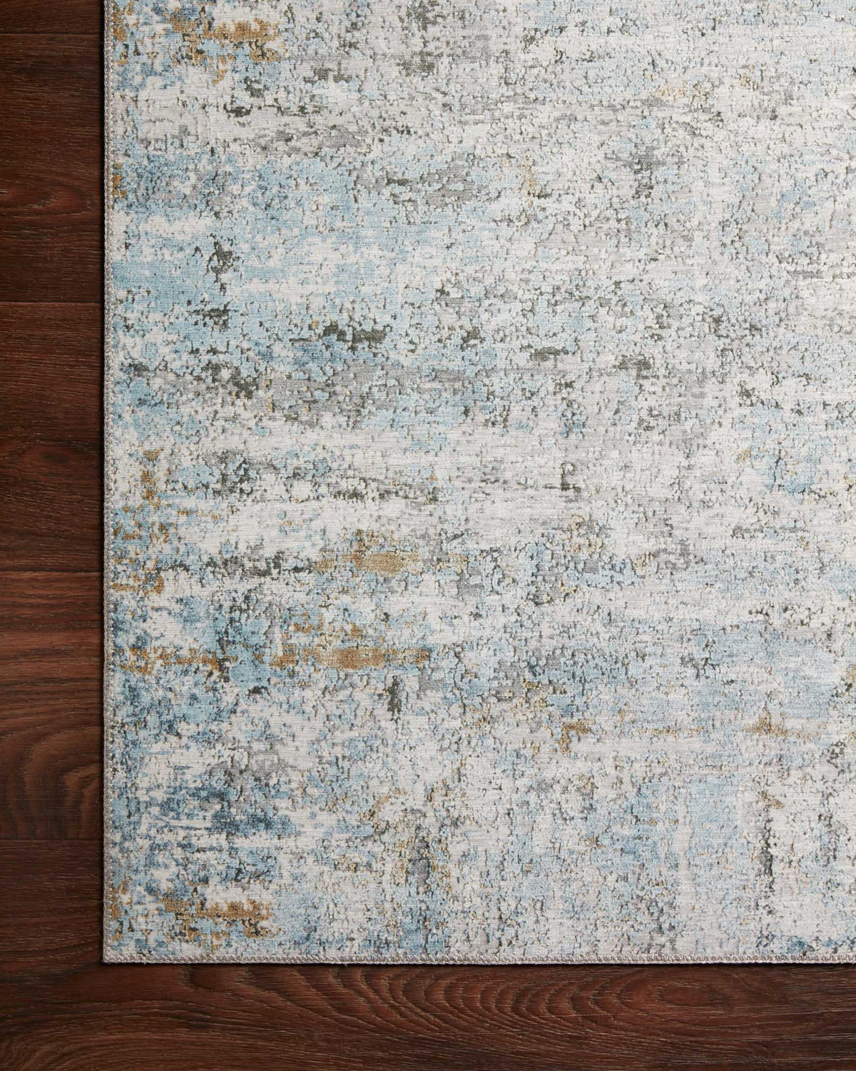 Ivory and sky blue rug with distressed pattern and visible border edge