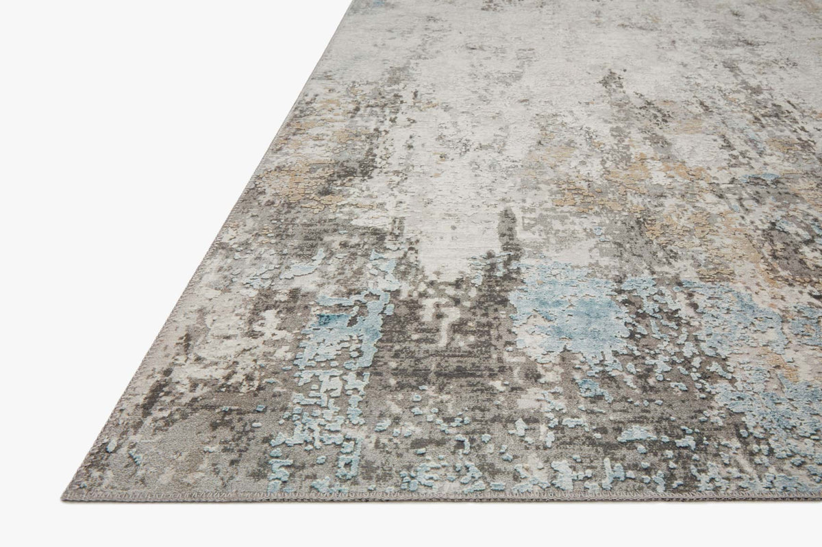 Rectangular rug with faded gray, ivory, and light blue textured abstract pattern