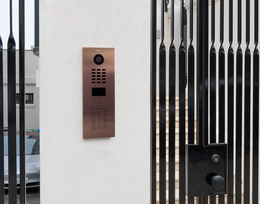 Bronze IP video door intercom panel with camera lens, speaker grille, and keypad