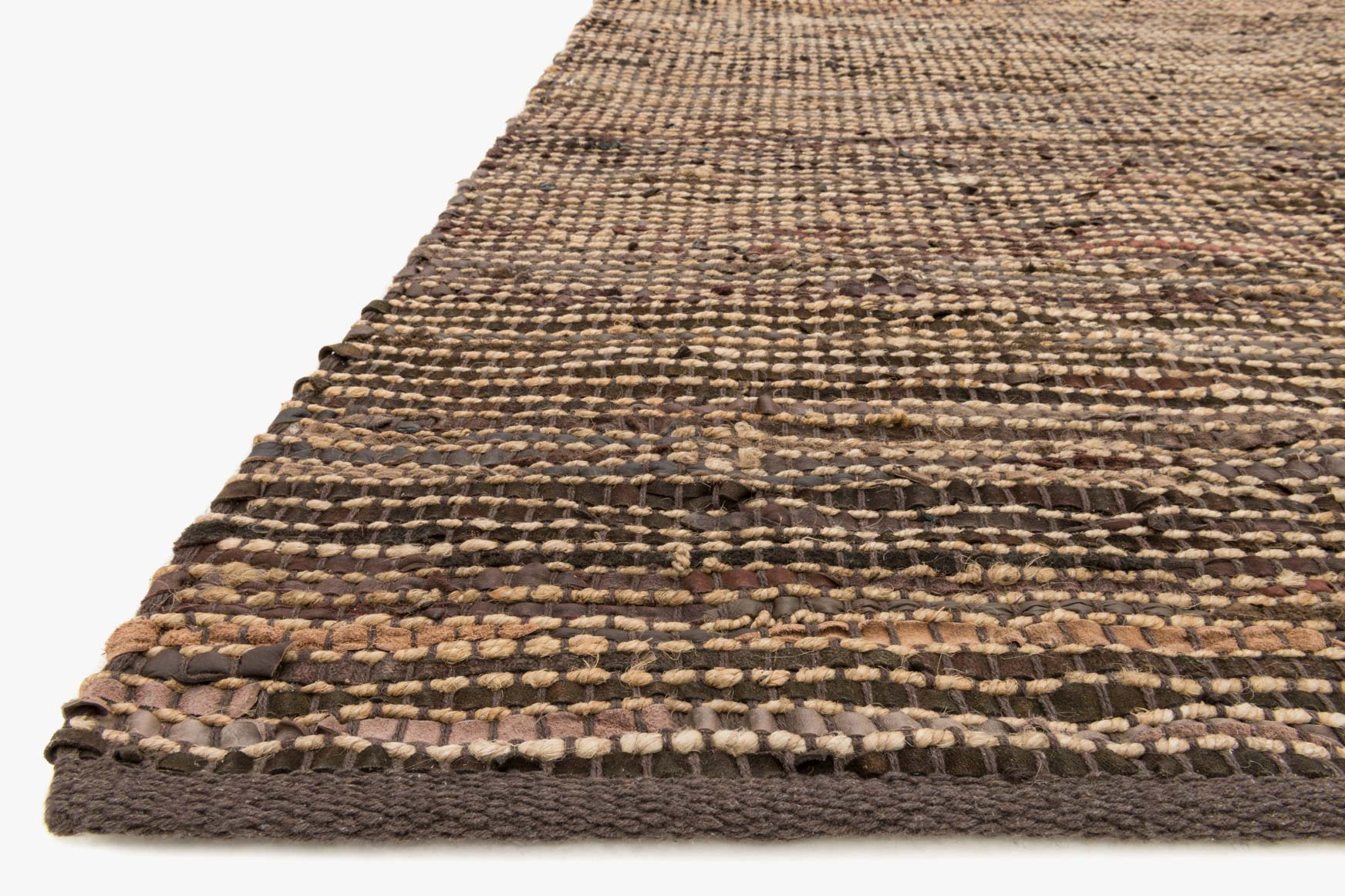 Brown hand-woven rug corner detail with braided texture and layered fringe