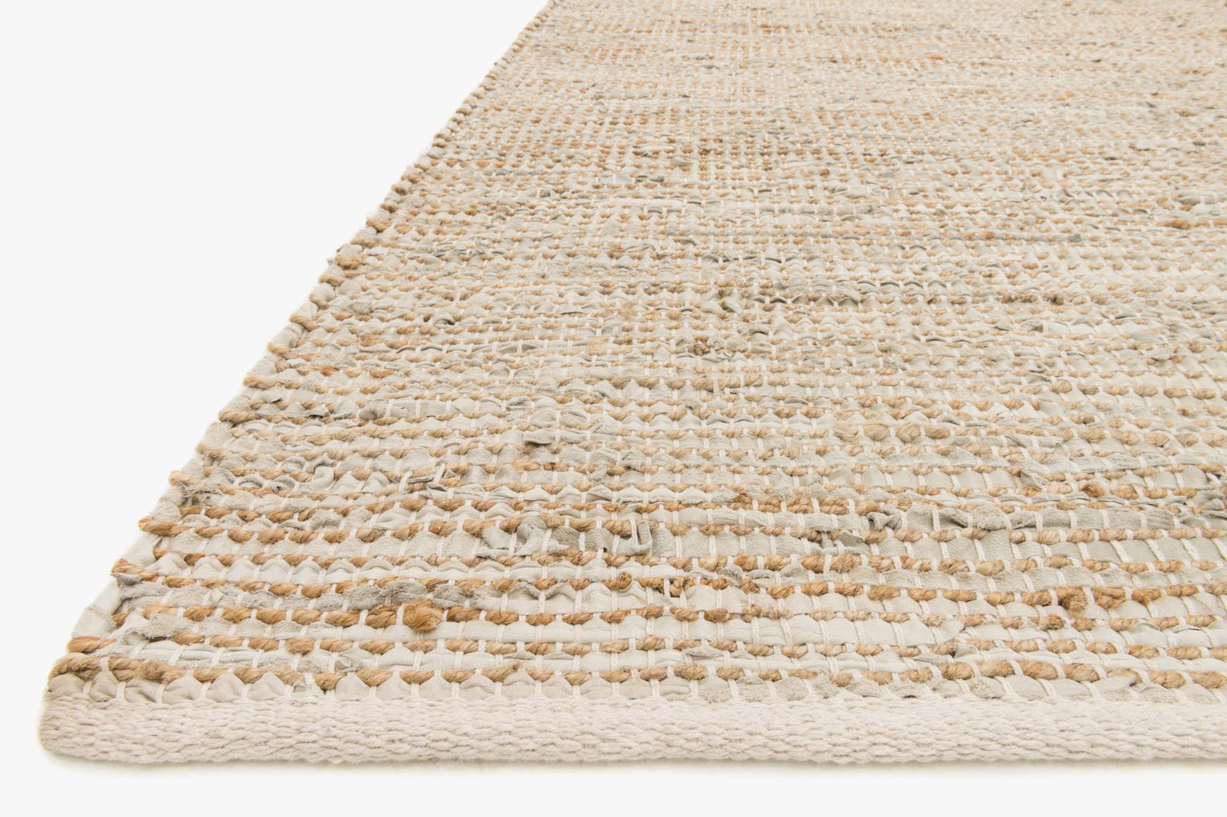 Ivory hand-woven rug corner with braided fringe edge and textured looped weave