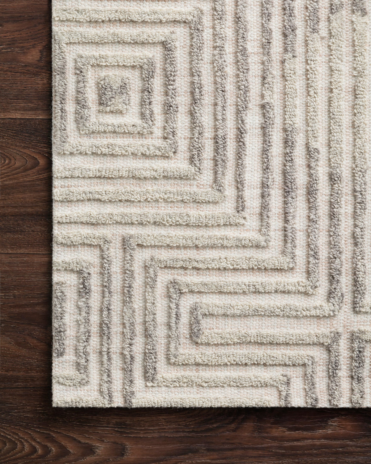 Hand tufted grey and silver rug corner with raised squared geometric design