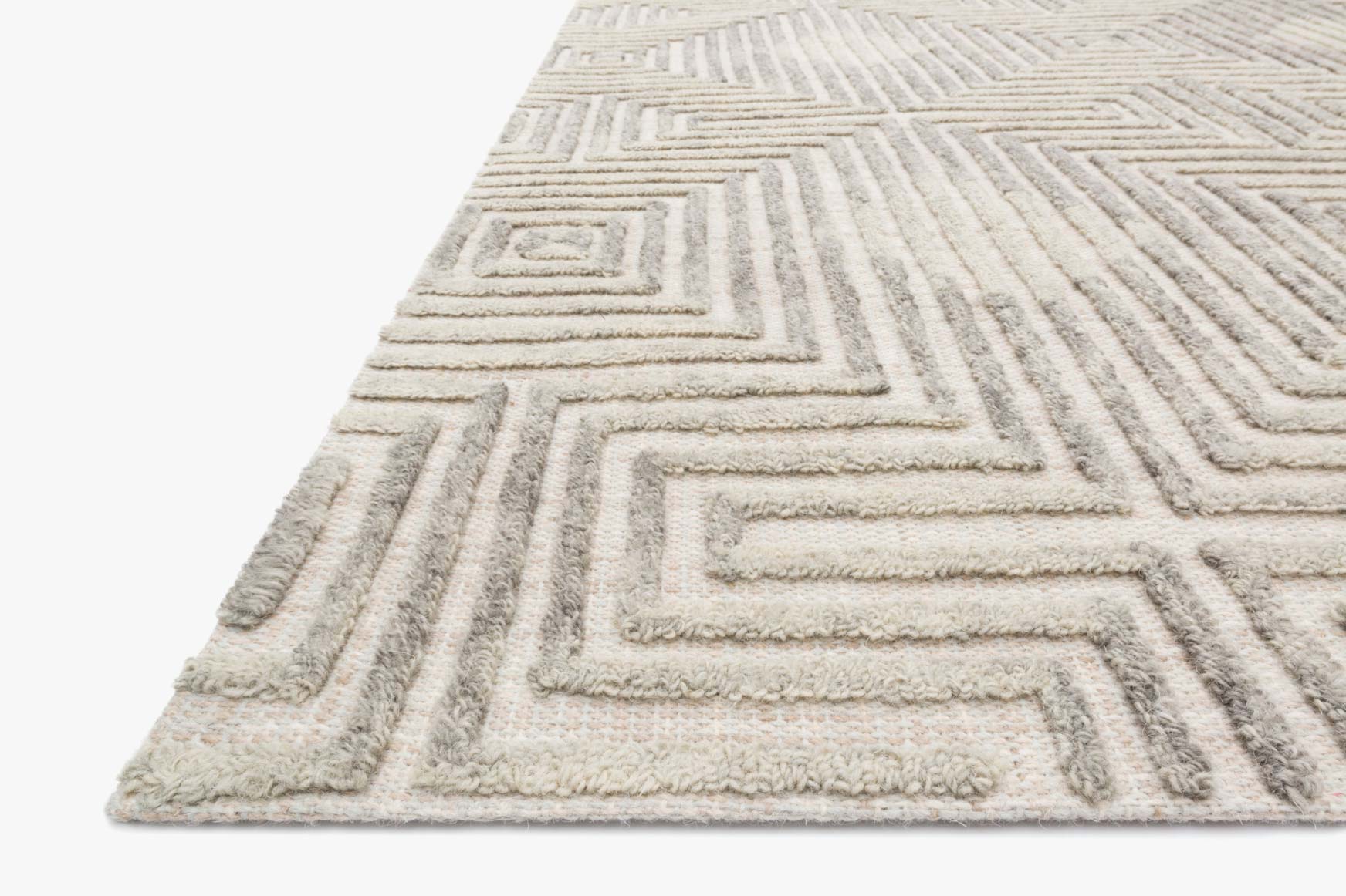 Hand tufted grey and silver rug, close-up of textured geometric border pattern