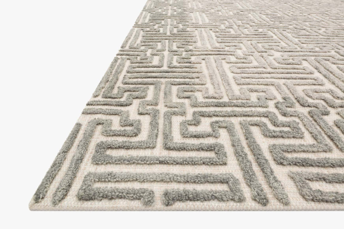 Stone and sand geometric rug with raised maze motif, corner close-up