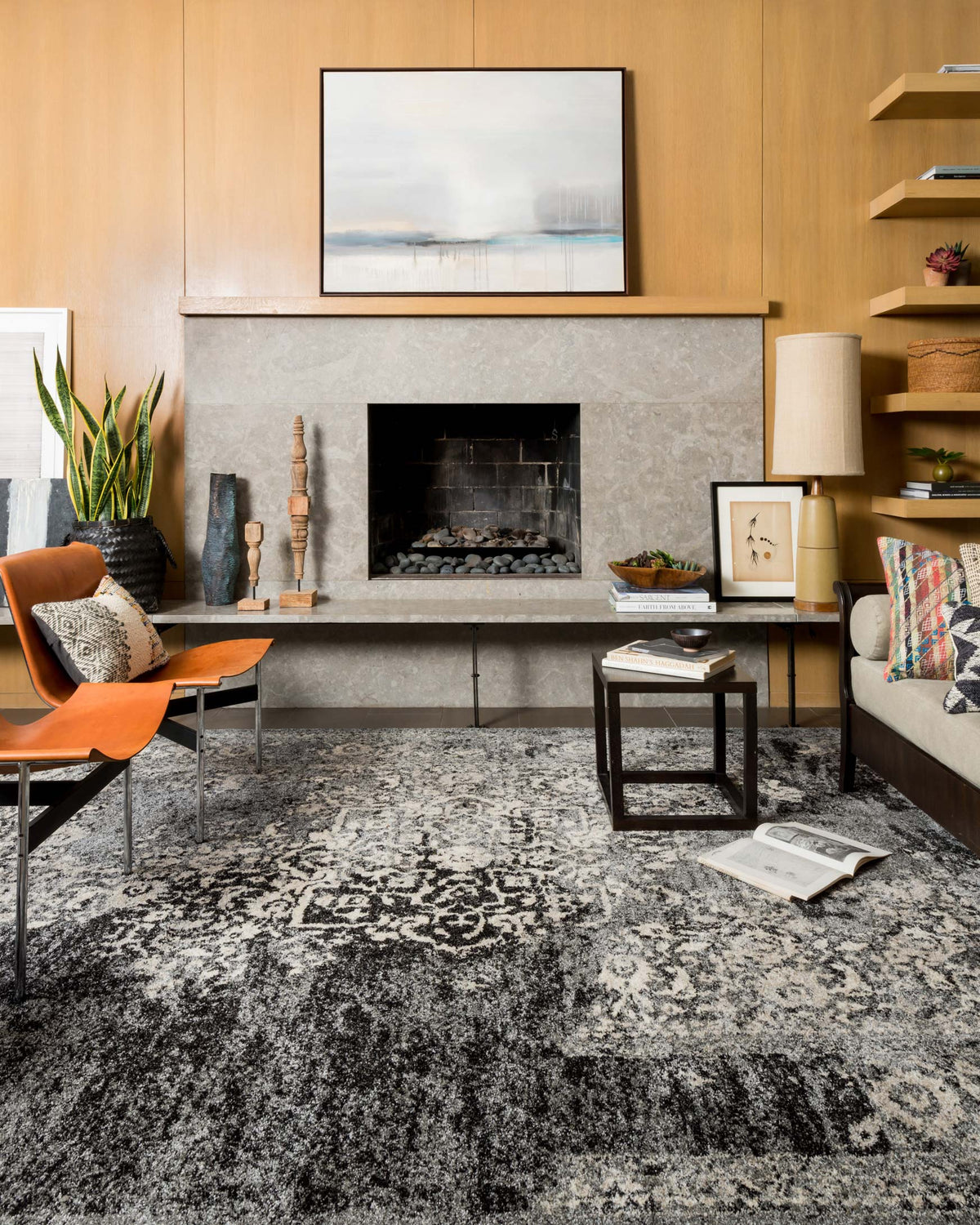 Black and ivory area rug with distressed damask-style pattern and short pile
