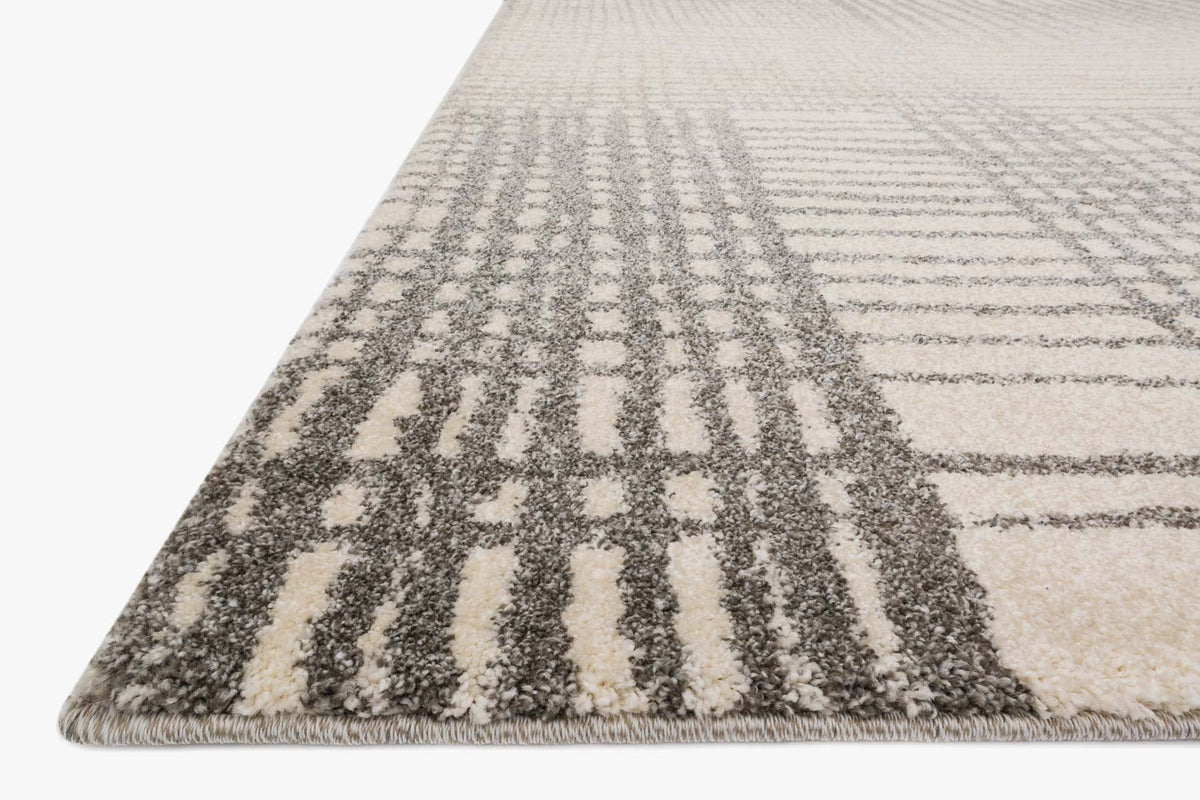 Ivory and grey rug corner detail with dense vertical stripes and woven grid texture