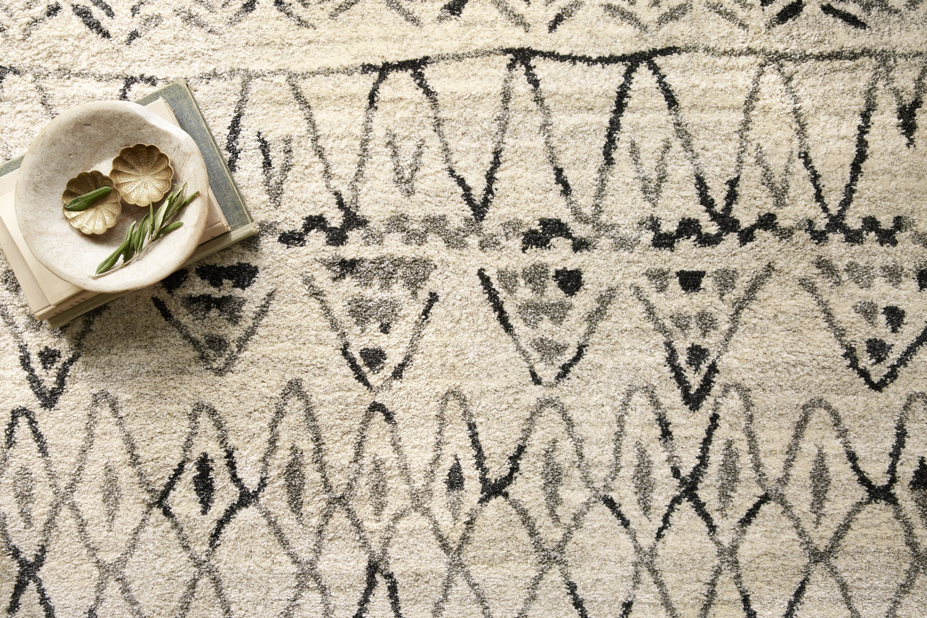 Close-up of heather gray area rug with black geometric lines and soft pile