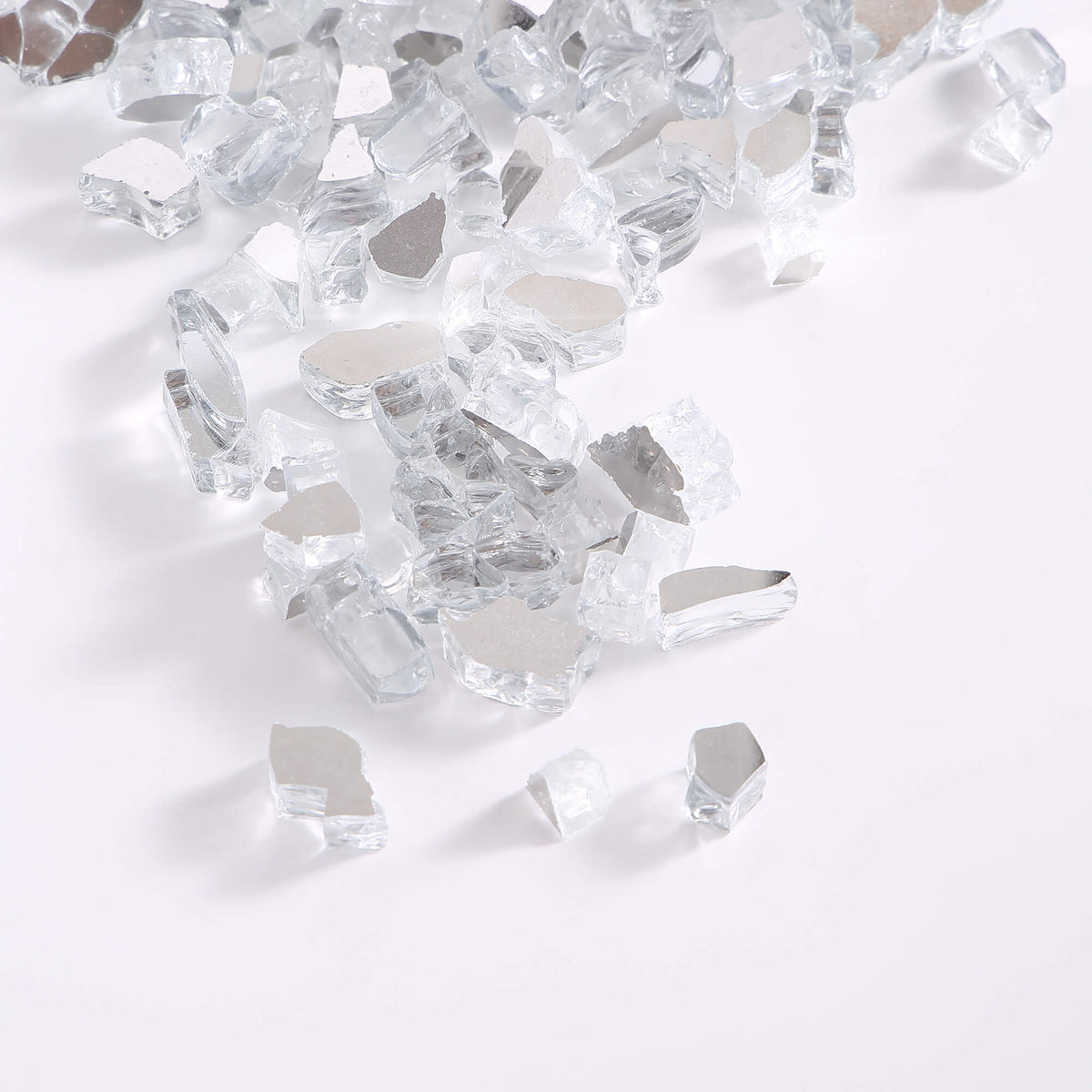 Pile of crystal ice tempered fire glass cubes, clear reflective glass chunks for fireplaces