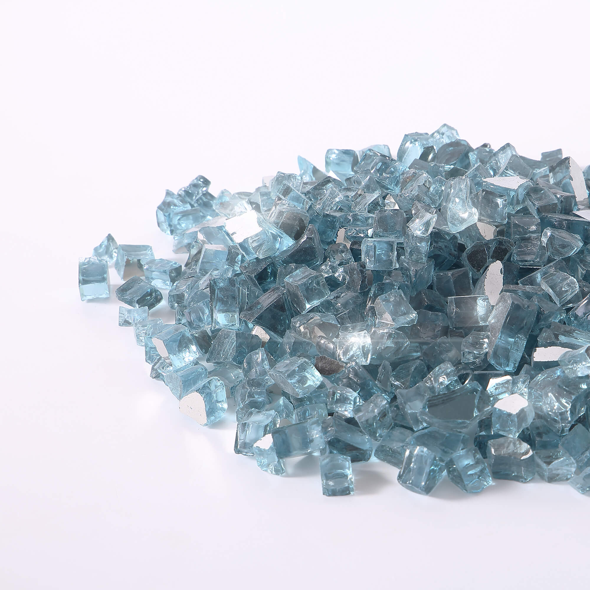 Pile of Caribbean blue tempered reflective fire glass cubes and shards